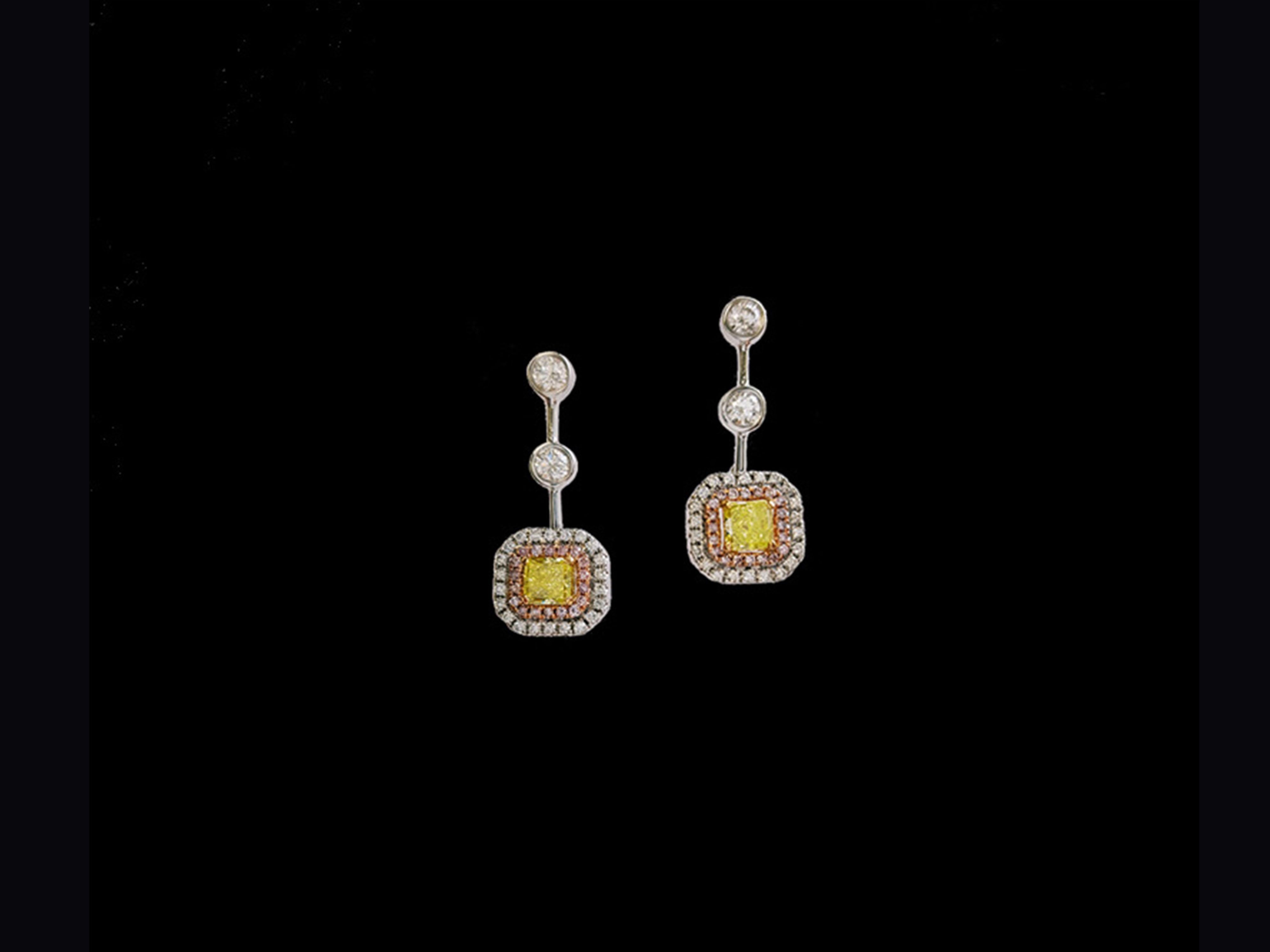 Novel Collection showcasing a stunning pair of 0.76 carat Fancy Intense Green-Yellow radiant cut diamond, GIA certified as SI1 clarity. Set with a perfect match of 4 round brilliant white diamonds at 0.40 carat and pink and white diamonds halo drop