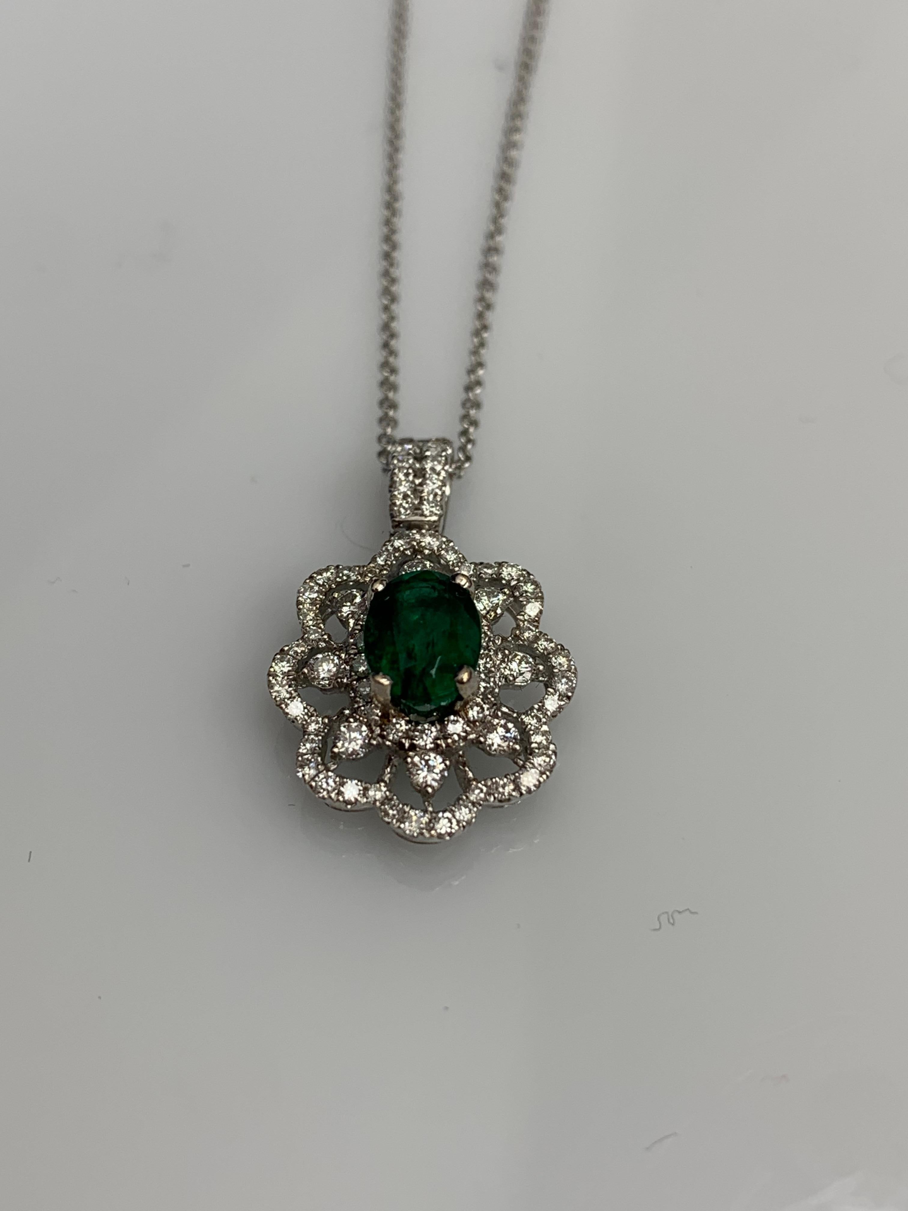 Modern 0.76 Carat Oval Cut Emerald Diamond Halo Flower Pendant Necklace in 18K For Sale