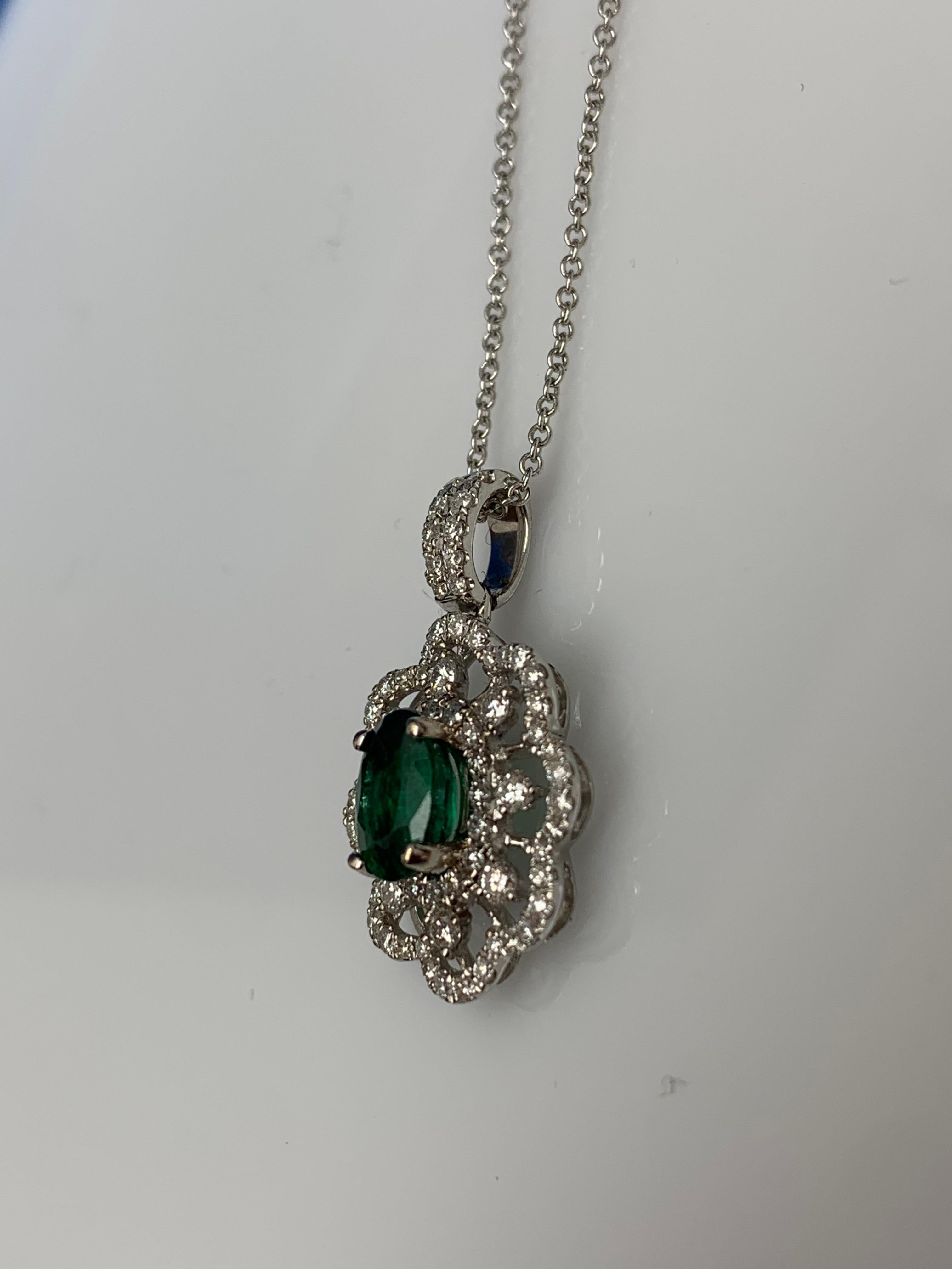 0.76 Carat Oval Cut Emerald Diamond Halo Flower Pendant Necklace in 18K In New Condition For Sale In NEW YORK, NY
