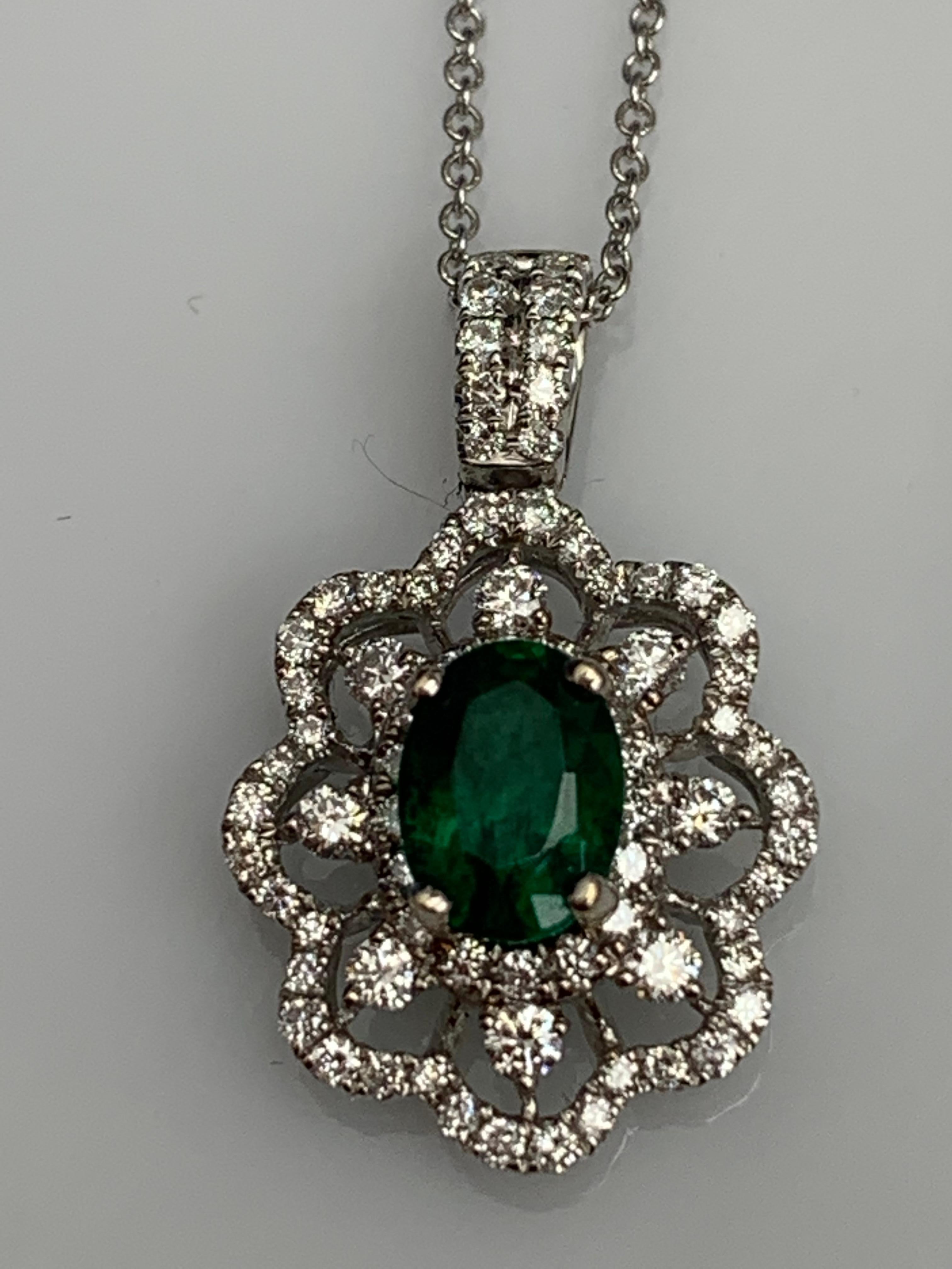 Women's 0.76 Carat Oval Cut Emerald Diamond Halo Flower Pendant Necklace in 18K For Sale