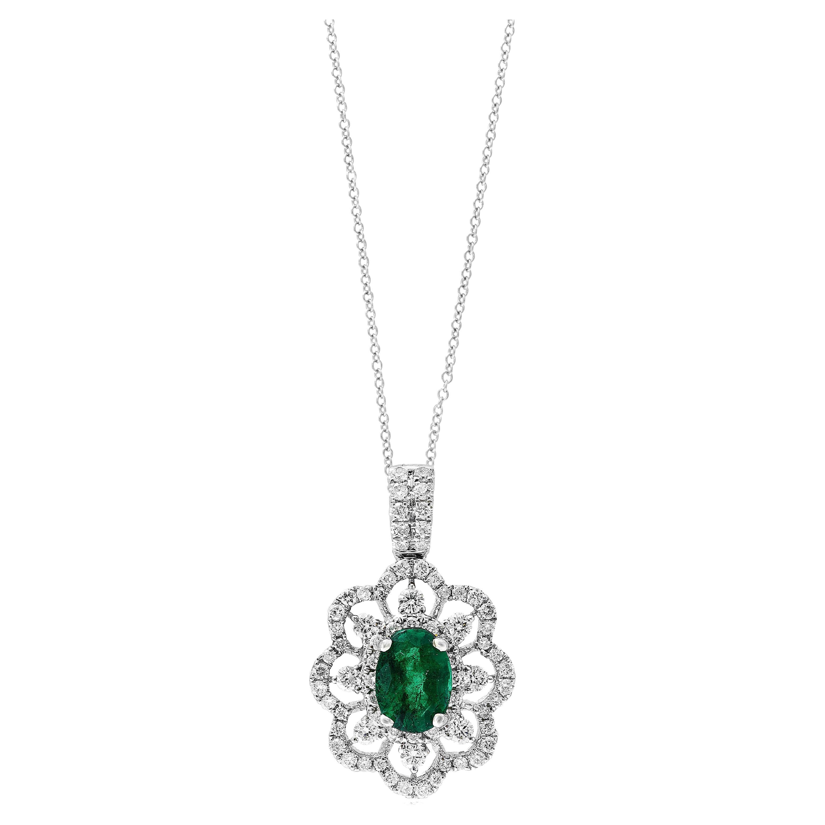 0.76 Carat Oval Cut Emerald Diamond Halo Flower Pendant Necklace in 18K For Sale