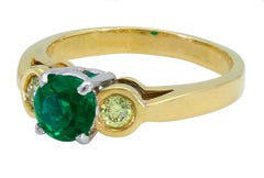 0.76 Carat Round Green Emerald and Yellow Diamond Three-Stone Engagement Ring