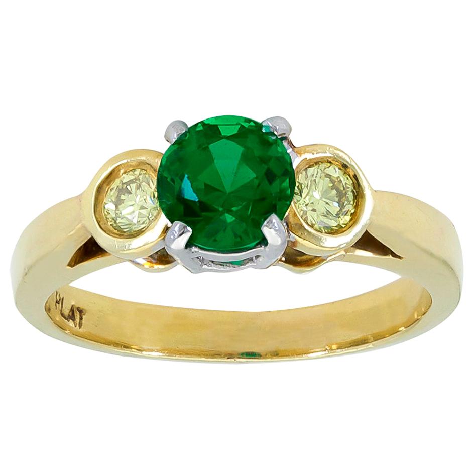 0.76 Carat Round Green Emerald and Yellow Diamond Three-Stone Engagement Ring For Sale