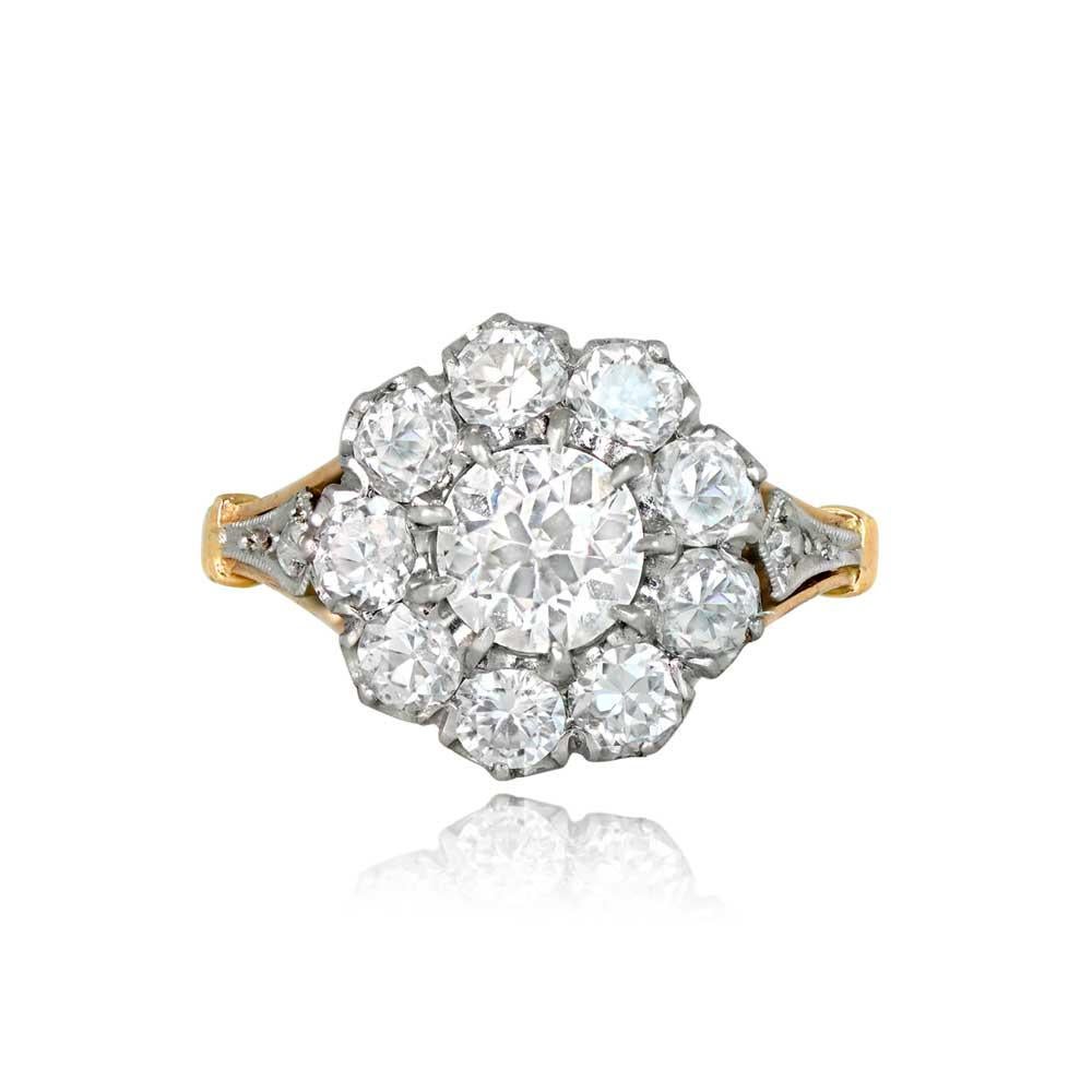 A stunning cluster diamond engagement ring featuring a central 0.76 carat old European cut diamond. Encircling the center stone is a cluster of additional old European cut diamonds. The center diamond boasts a J color and VS2 clarity. Hand-crafted