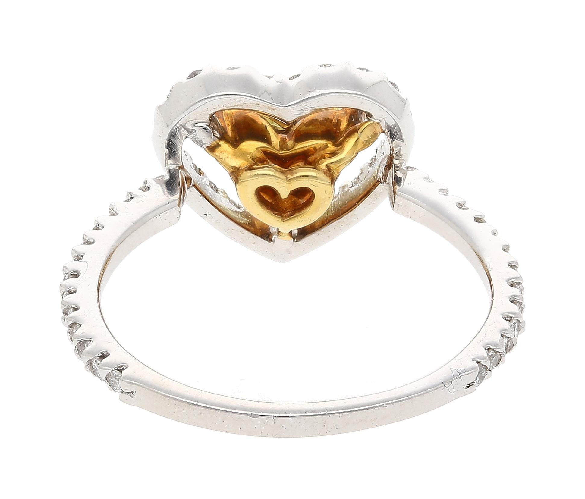 Floating Fancy Yellow Heart Diamond & Diamond Engagement Ring

Crafted from both platinum 950 and 18k yellow gold, this romantic engagement ring boasts a floating fancy yellow diamond center stone. The yellow diamond is heart-shaped and weighs 0.77