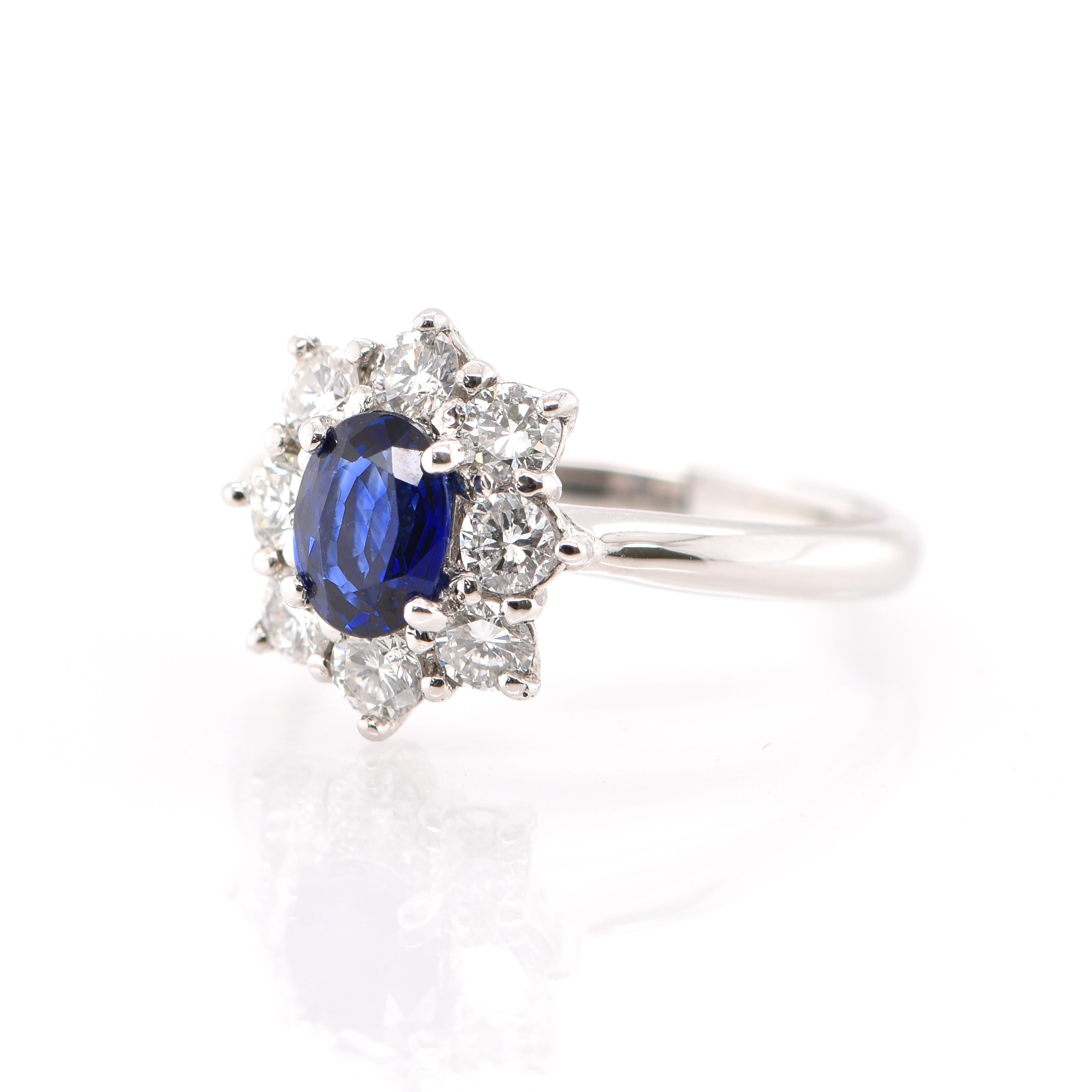 A stunning Halo Engagement Ring featuring a 0.77 Carat Natural Sapphire and 0.60 Carats of Diamond Accents set in Platinum. Sapphires have extraordinary durability - they excel in hardness as well as toughness and durability making them very popular