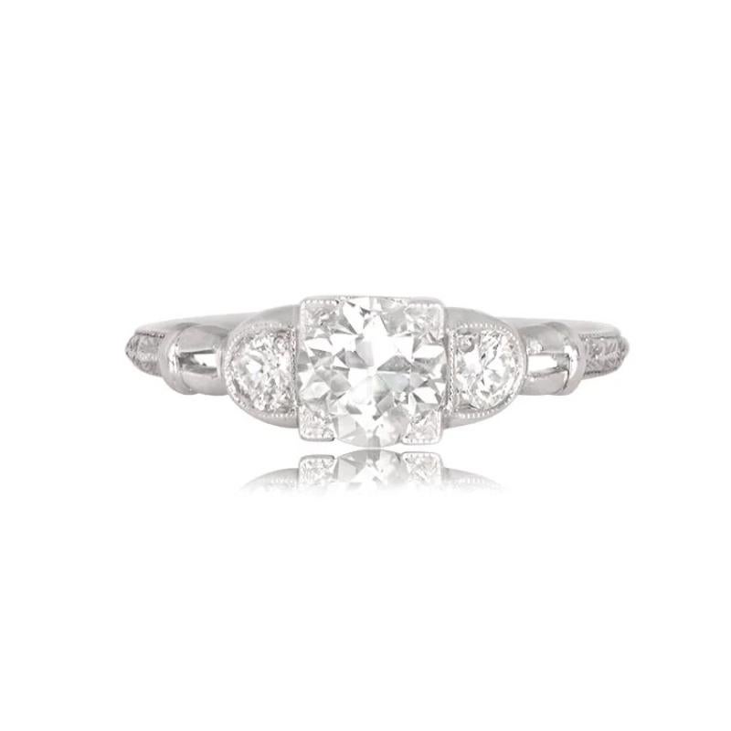 This ring has an antique diamond that showcases an exquisite old European cut center diamond, flanked by two smaller diamonds in a handcrafted platinum setting. The center diamond weighs 0.77 carats and has K color and VS2 clarity, held by square