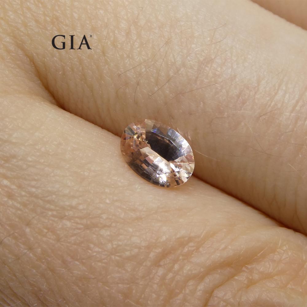 Women's or Men's 0.77 Carat Oval Orangy Pink Padparadscha Sapphire GIA Certified East Africa For Sale