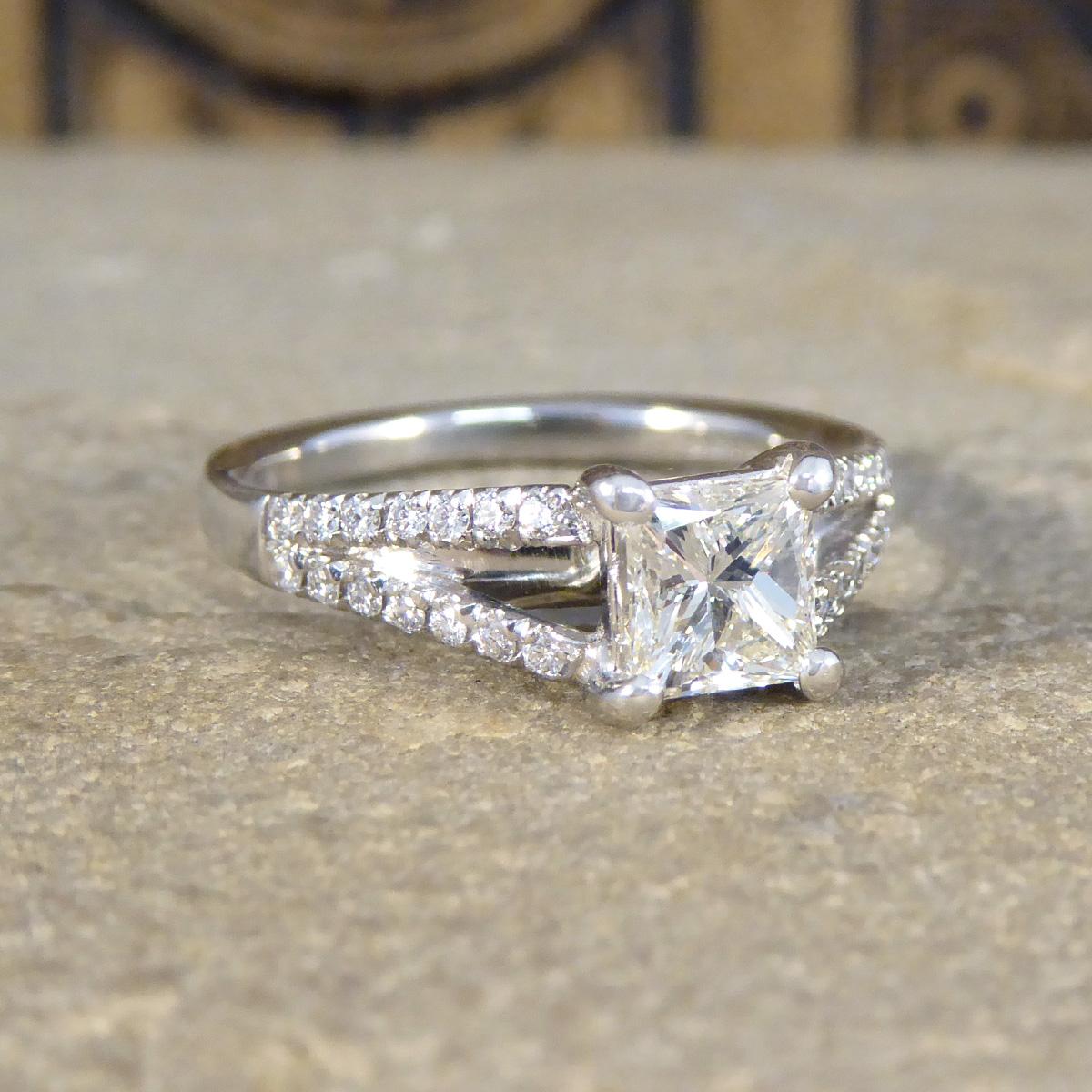 Introducing our exquisite 0.77ct Princess Cut Diamond ring, a masterpiece of design and craftsmanship set in luxurious Platinum. At the heart of this stunning ring sits a princess cut diamond weighing approximately 0.77ct, renowned for its sharp