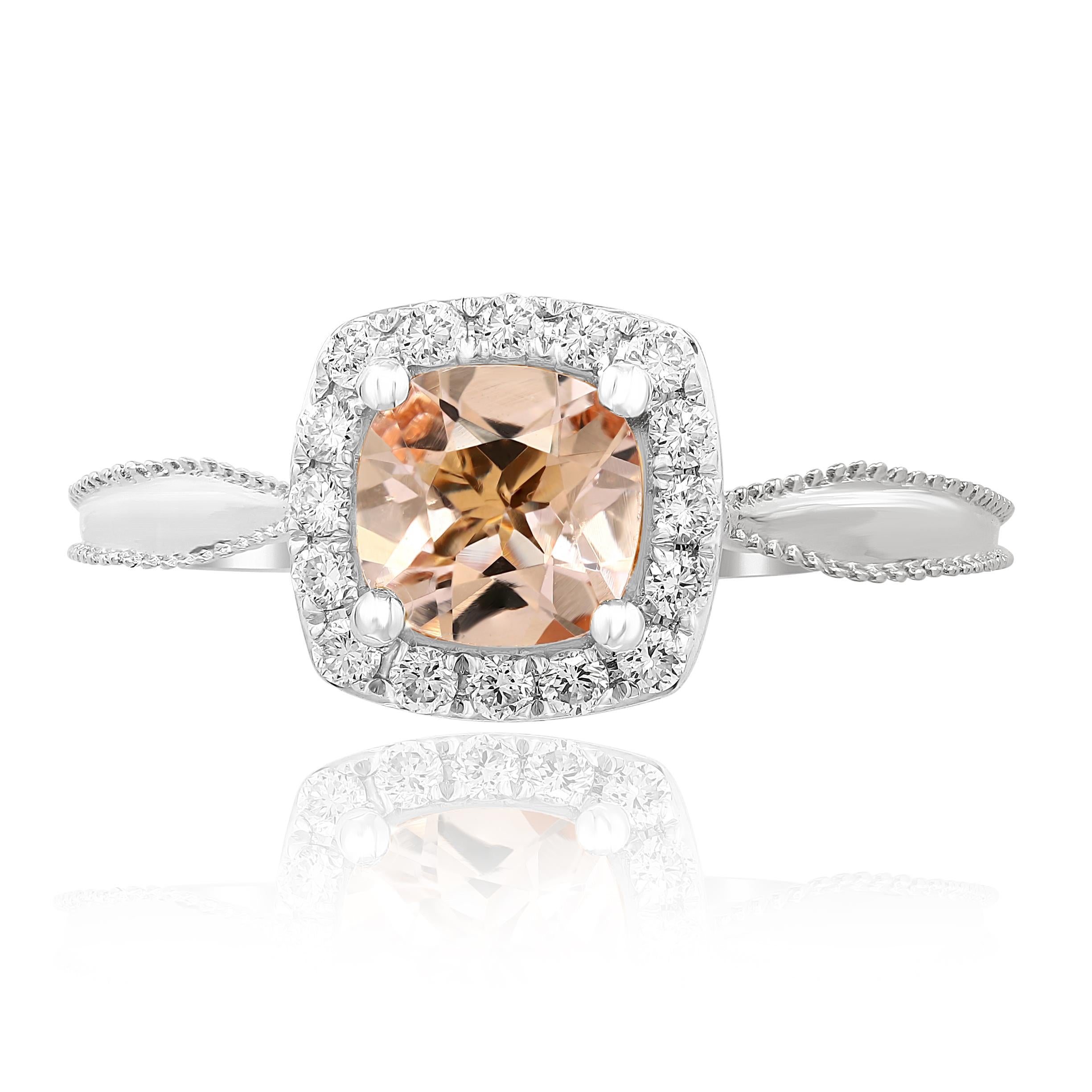This classic Morganite Ring has a Cushion Cut 0.78 Carat Morganite as its center and is surrounded by 16 Round Cut Diamonds that weigh 0.25 Carats in 18K White Gold.