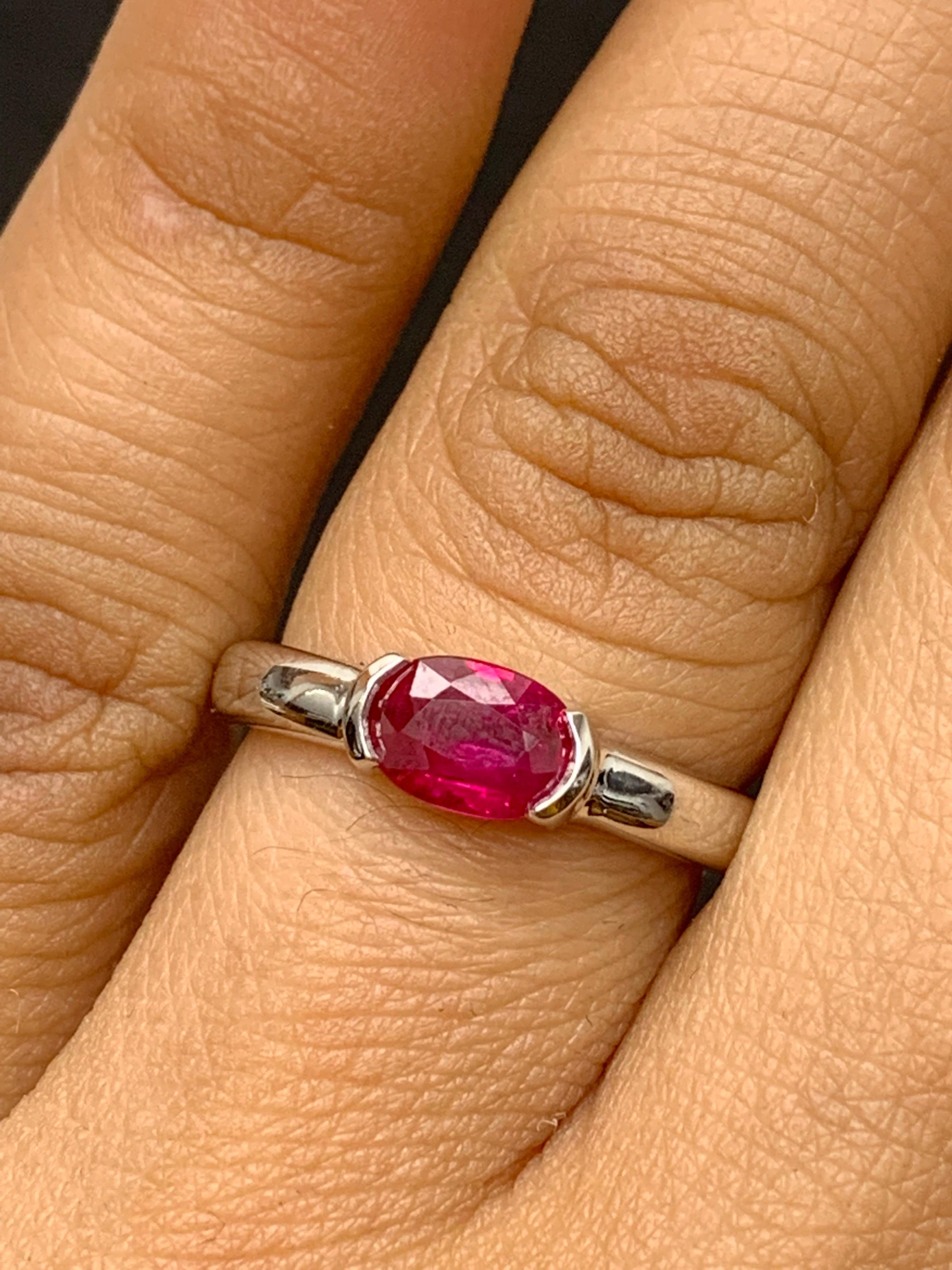 An elegant wedding band ring featuring an astonishing 0.78-carat oval cut ruby, set in a beautiful wide 14K white gold band. 

Style is available in different price ranges. Prices are based on your selection. Don't hesitate to get in touch with us