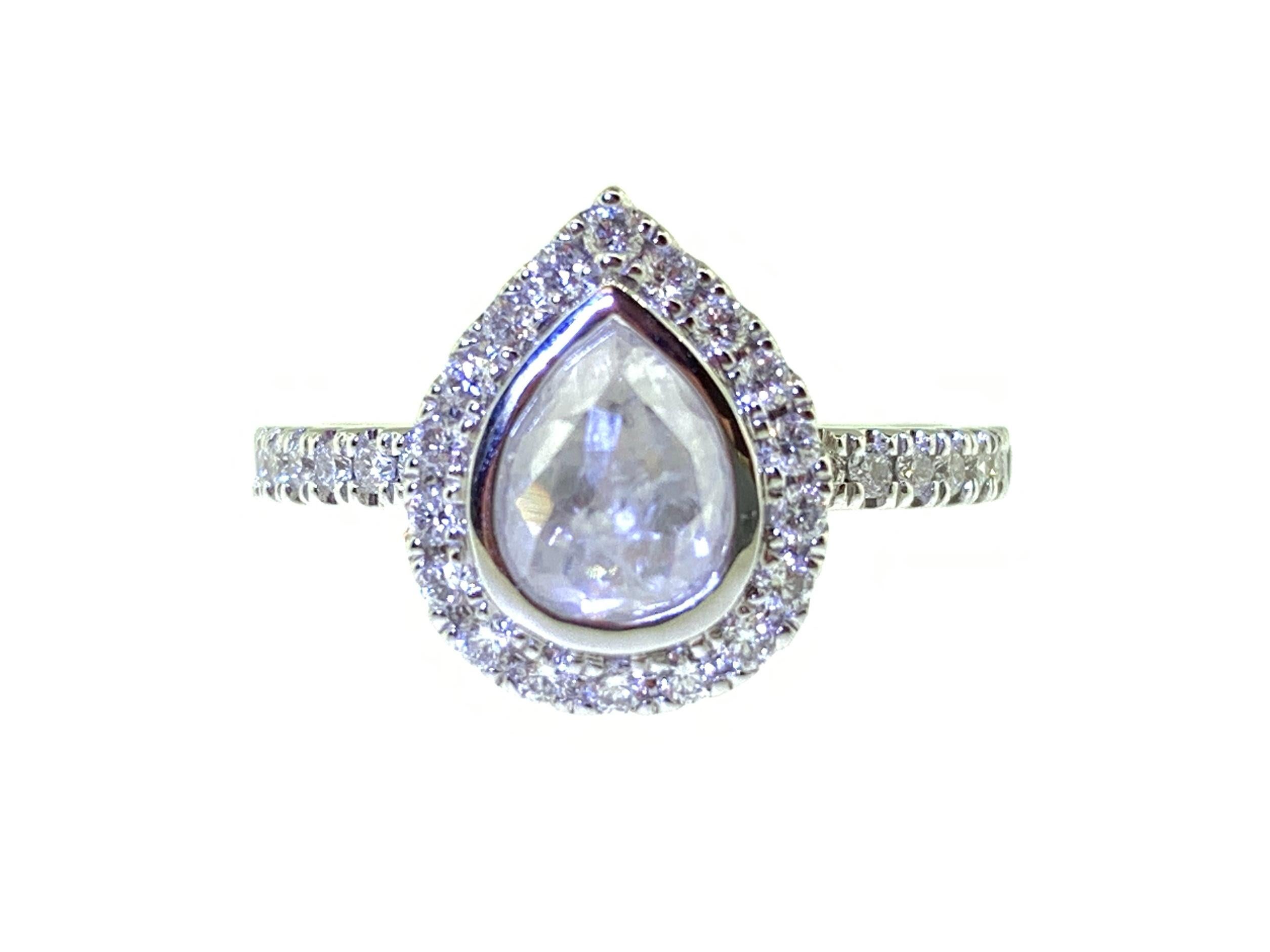 This stunning ring features a 0.78 Carat Rose Cut Pear Shape White Diamond with a Diamond Halo. This ring is set in 18k White Gold on a Diamond Shank. Total Diamond Weight (not including center stone) = 0.38 Carats. Ring Size = 6 1/2.