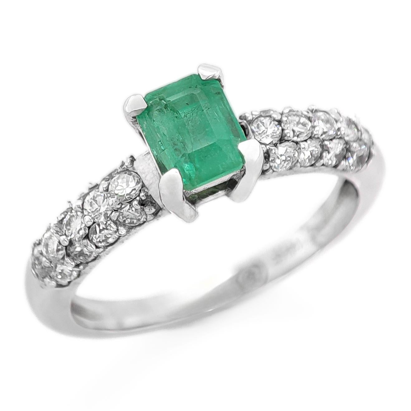 FOR US BUYER NO VAT

This charming ring features a 0.38 carat green emerald as its focal point, displaying the enchanting green hue that emeralds are known for.

Enhancing the emerald's beauty are 26 diamonds, totaling 0.40 carats. These diamonds