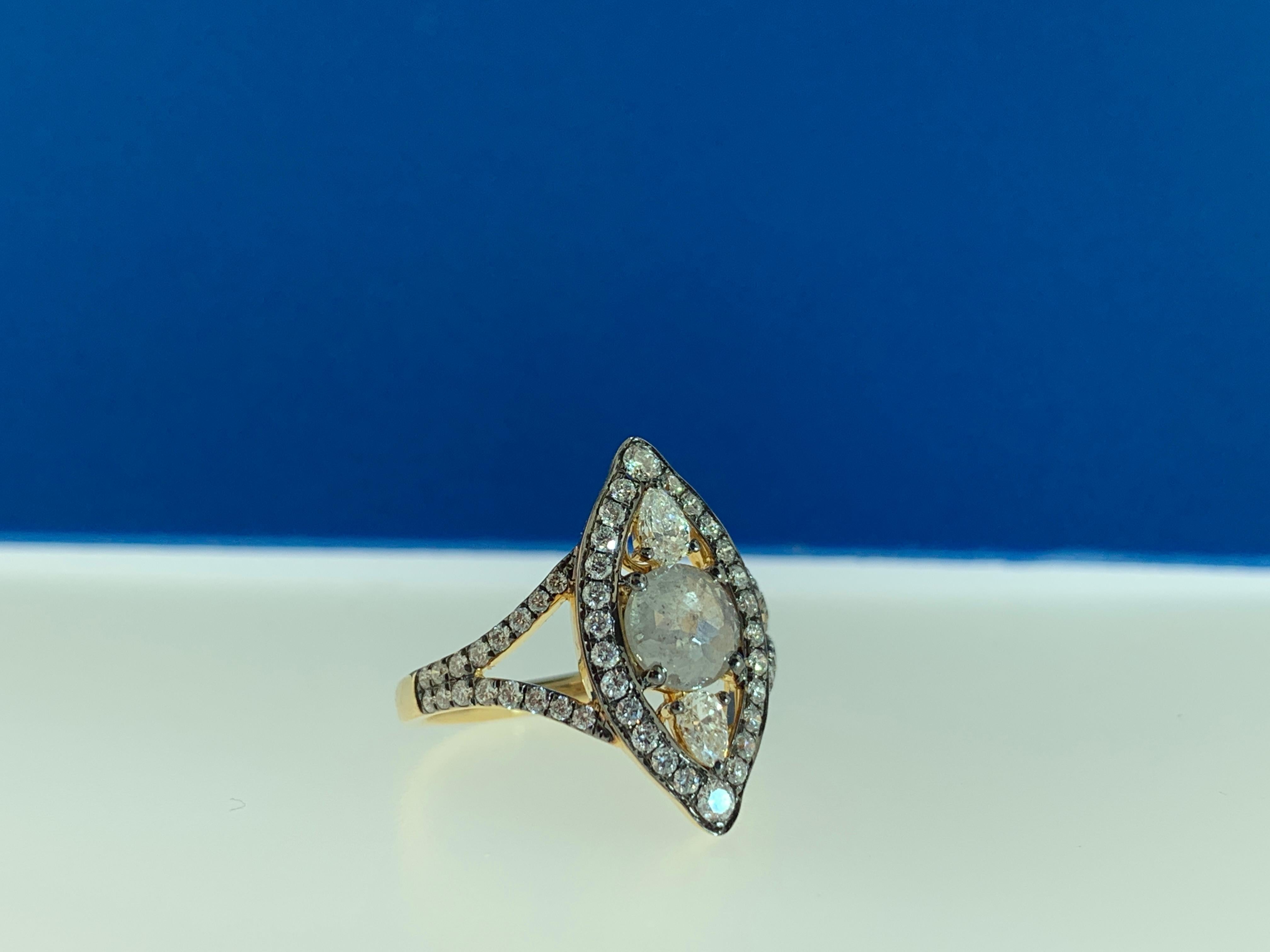 This stunning cocktail ring showcases a unique 0.79 carat rose cut grey - white diamond, flaked by 2 pear shape white diamonds with surrounding white diamonds in the style of art nouveau, set in 18 karat yellow gold, on a double diamond shank.