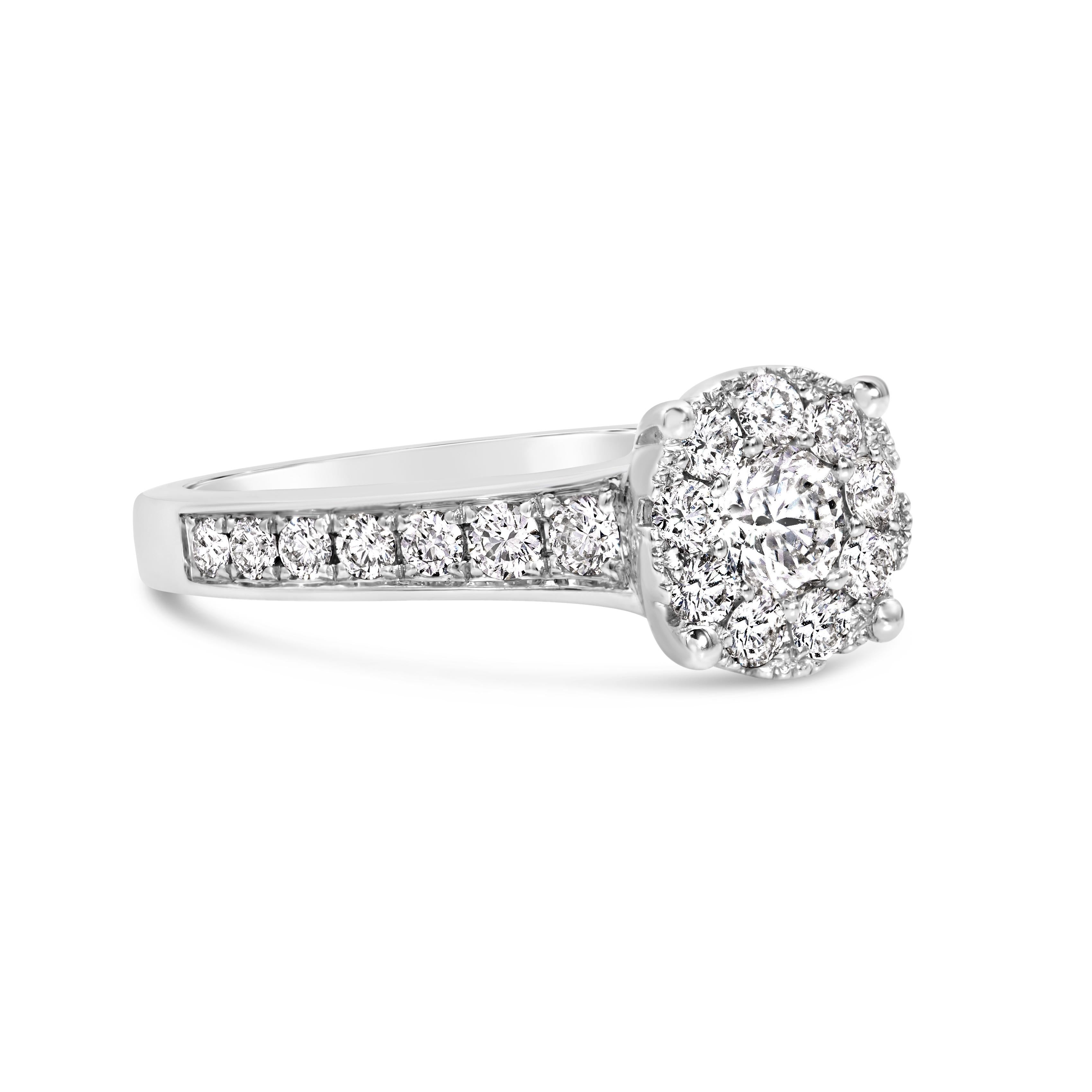 A gorgeous engagement ring, showcasing a cluster of round brilliant cut diamonds weighing 0.54 carat total. Accented by a diamond encrusted shank of round cut diamonds weighing 0.25 carat total, set in a half-eternity design. Finely made with 18K