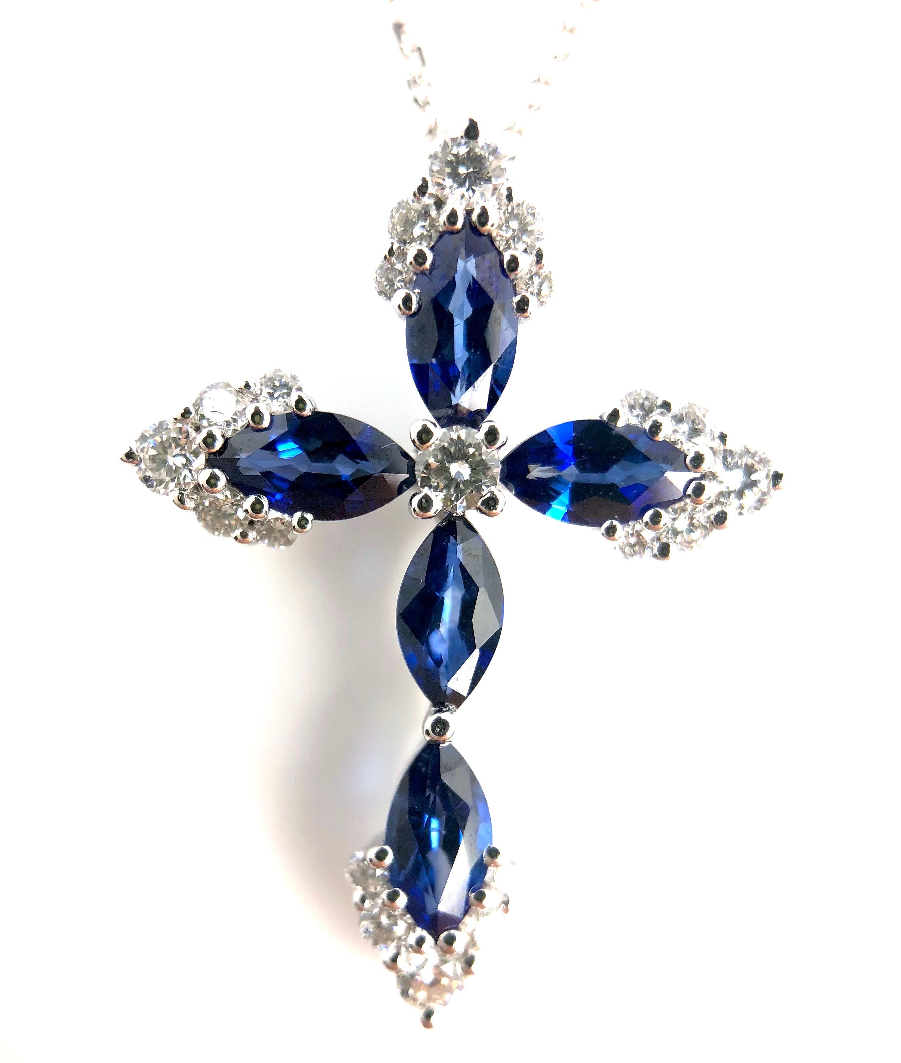 This lovely halo cross pendant features 5 marquise cut sapphires, total 0.79 carats, surrounded by 0.23 carats round diamonds.

Center: 0.79 carats blue sapphire
Diamond Halo: 21 round diamonds total 0.23 carats
Set in 18k White Gold.

Many of our