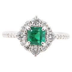 0.797 Carat Natural Emerald and Diamond Halo Ring Set in Platinum