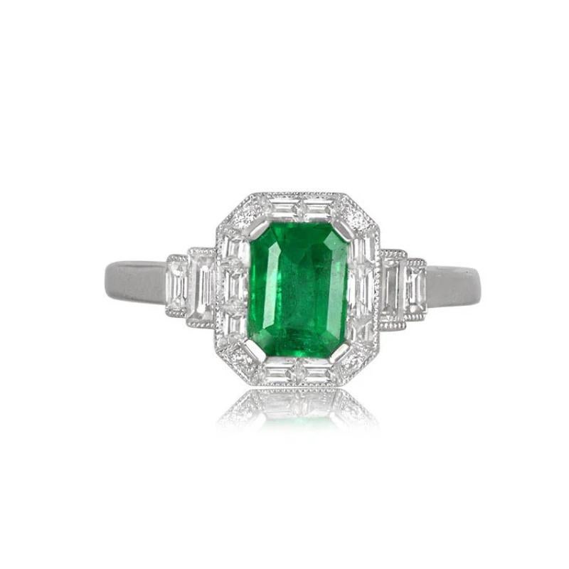 Emerald and Diamond Geometric Ring: An exquisite creation showcasing a vibrant natural emerald with captivating green saturation. The center gemstone is embraced by a halo of baguette-cut and round-cut diamonds. Additional baguette-cut diamonds