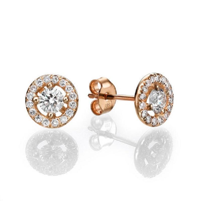 A beautiful Diamond stud earrings made of 14K Rose Gold set with a pair of excellent Round cut Diamond of SI1 clarity and F color accented by 30 natural round diamonds. The total carat weight of these Diamond studs is 0.80 carat.
 
 Center Stone:
