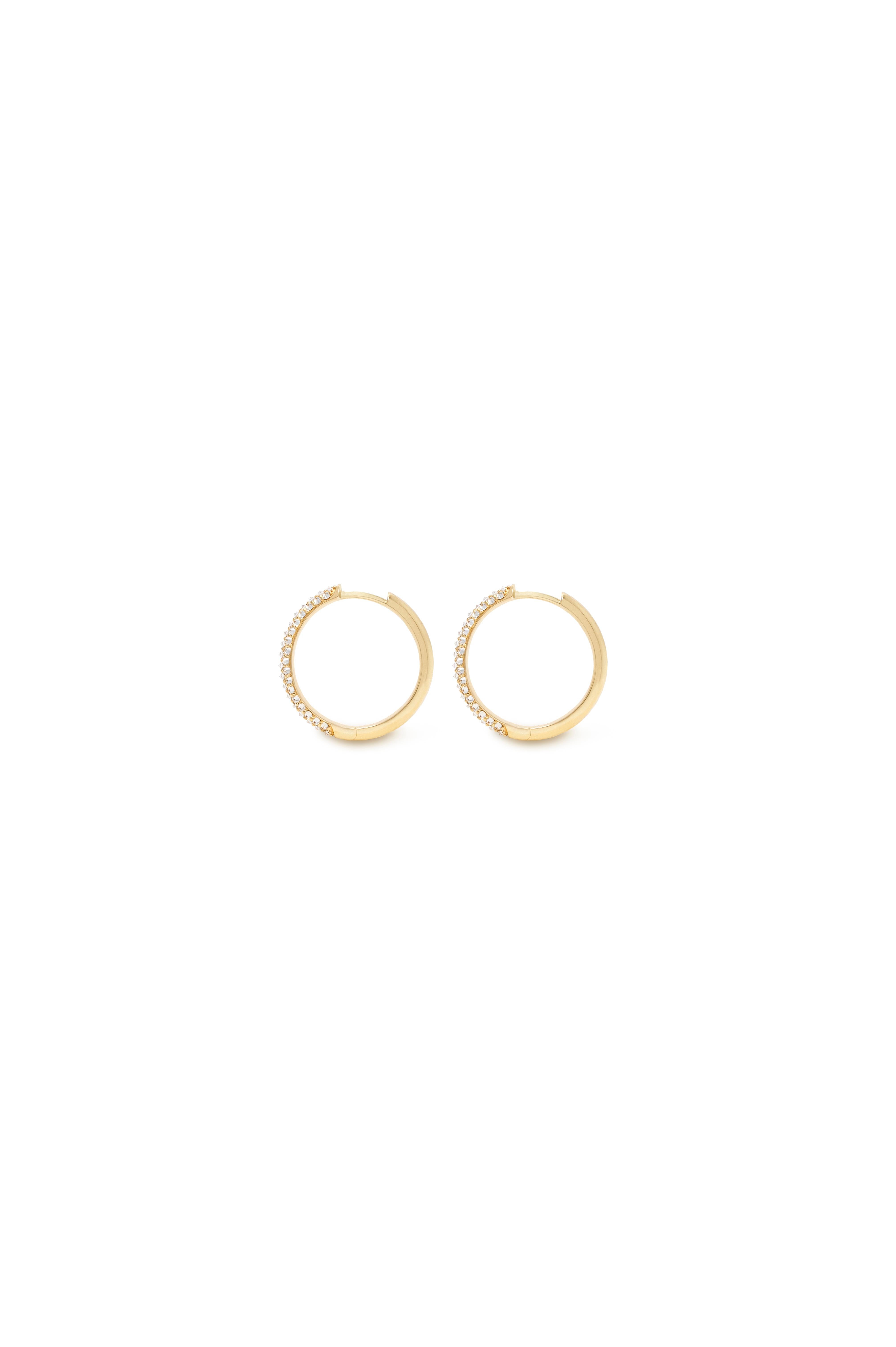 Discover luxury with The Up Hoops. These 18K yellow gold hoop earrings are adorned with glittering reverse set Canadian diamonds, adding a touch of opulence to any outfit. Elevate your style with these sophisticated and exclusive earrings.

From the