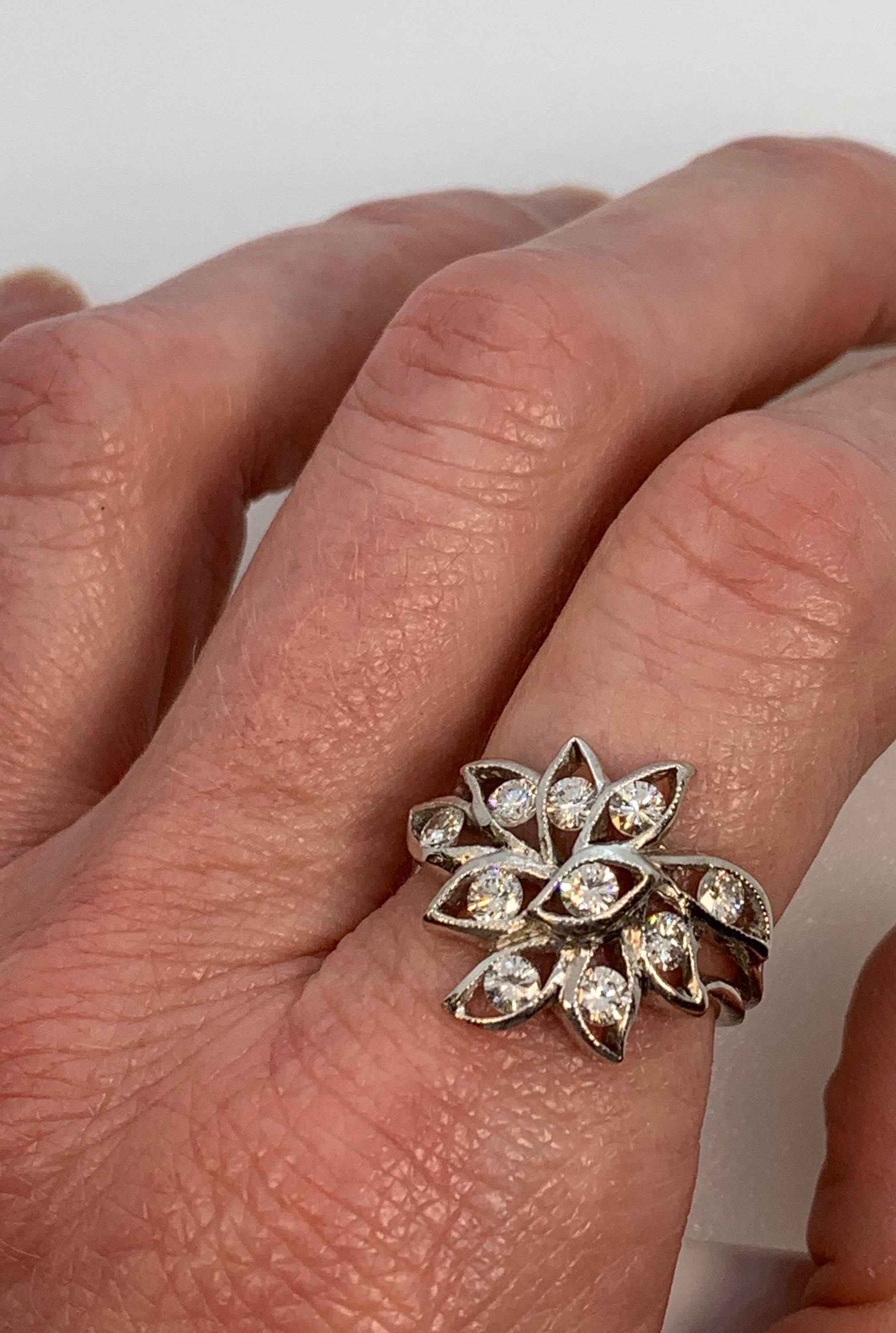 This one-of-a-kind ring was made by Eytan Brandes for a customer who traded it in a few years later for something bigger (of course).  It features a loose, leafy foliate design, with each petal or leaf holding a diamond.  The edges of each petal