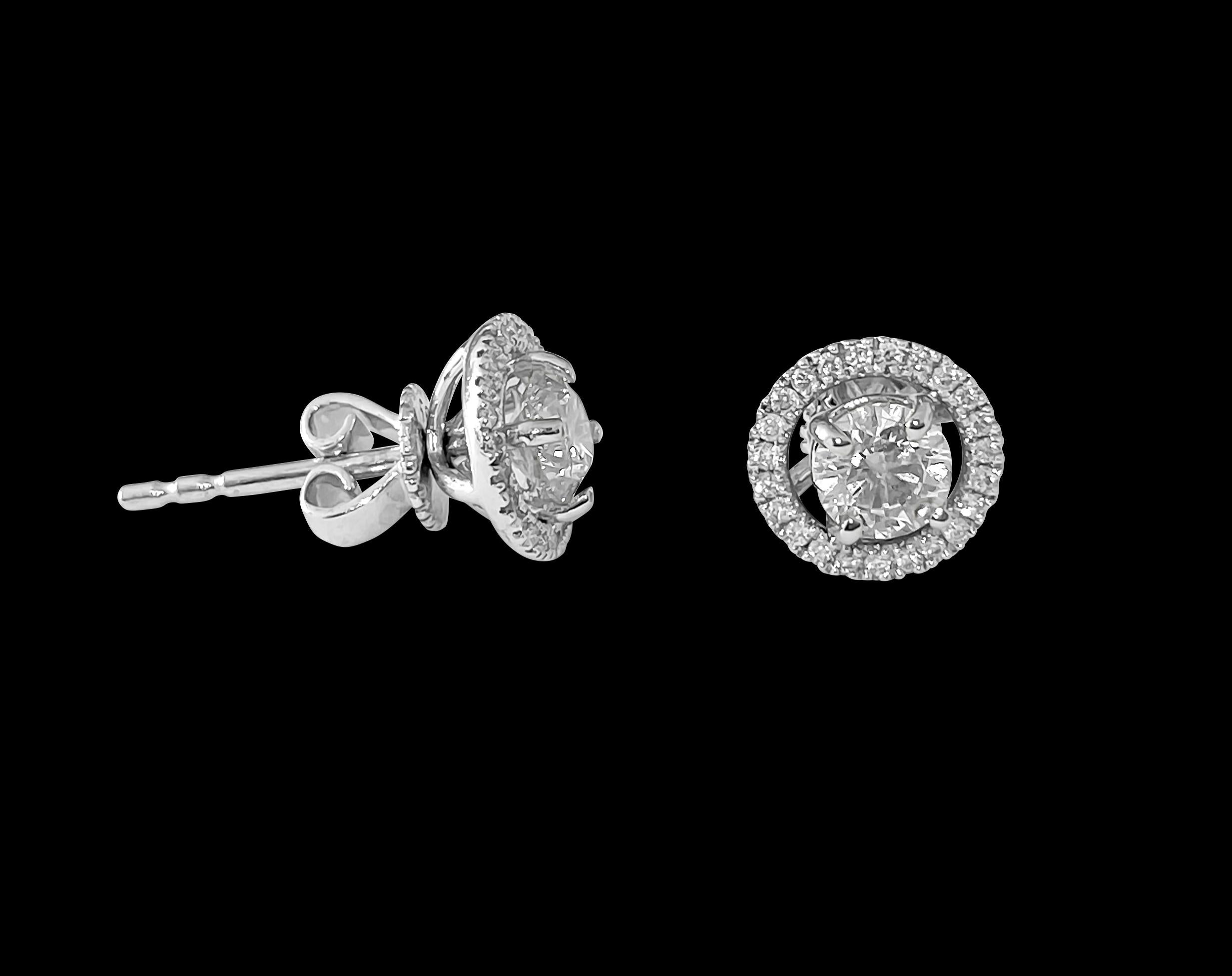 Metal: 18K white gold. 
Side diamonds: 0.30 carats. 
Center diamonds: 0.50 carats. Total carat weight of diamonds: 0.80 carats. 
Clarity: SI. Color: G. Round brilliant cut diamonds set in prongs. 

These are special jacket earrings. Transform your