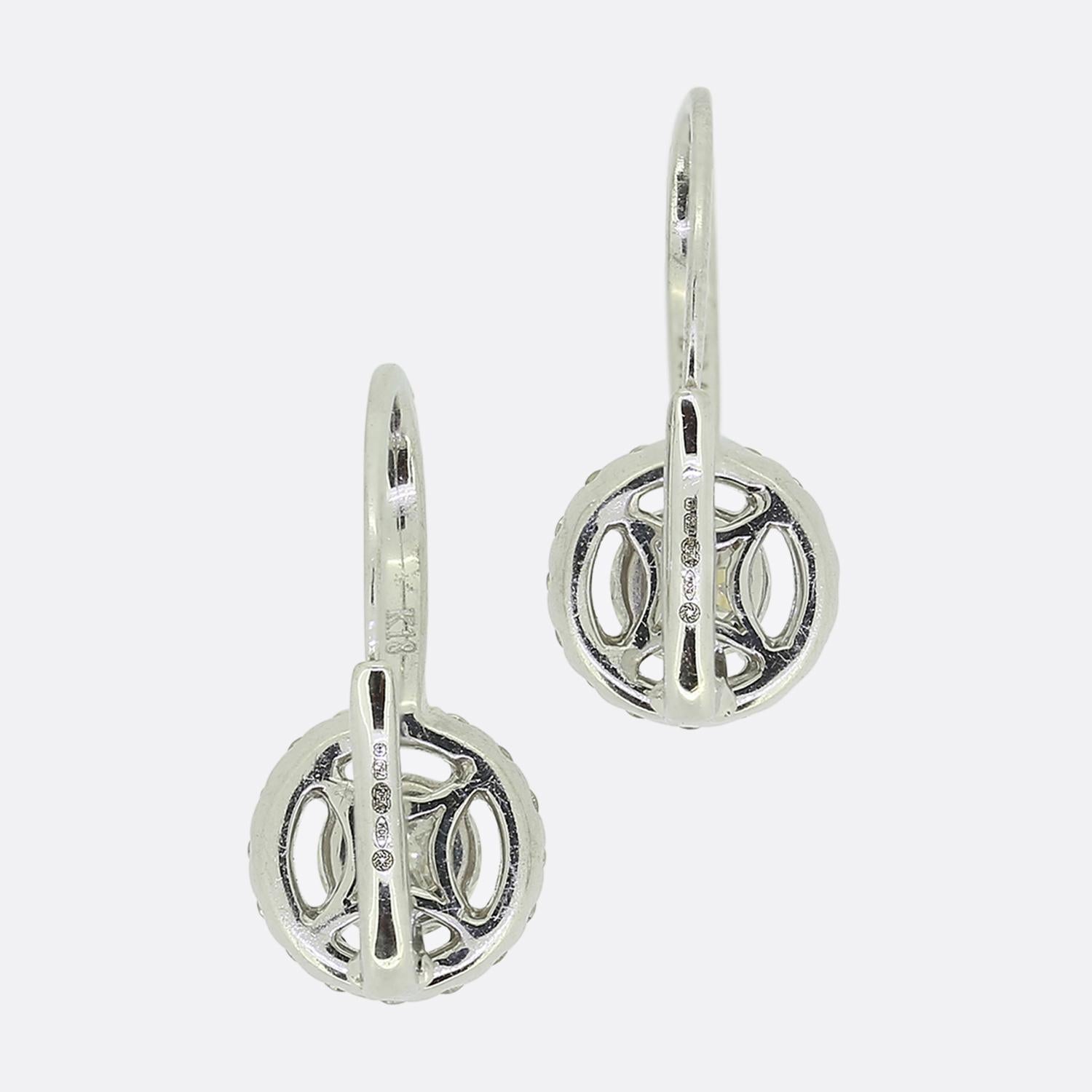 Here we have a wonderful pair of diamond drop earrings. Each identical piece has been crafted from 18ct white gold and focally showcases a single 0.40 carat round brilliant cut diamond at the centre. This principal stone is then surrounded by a halo
