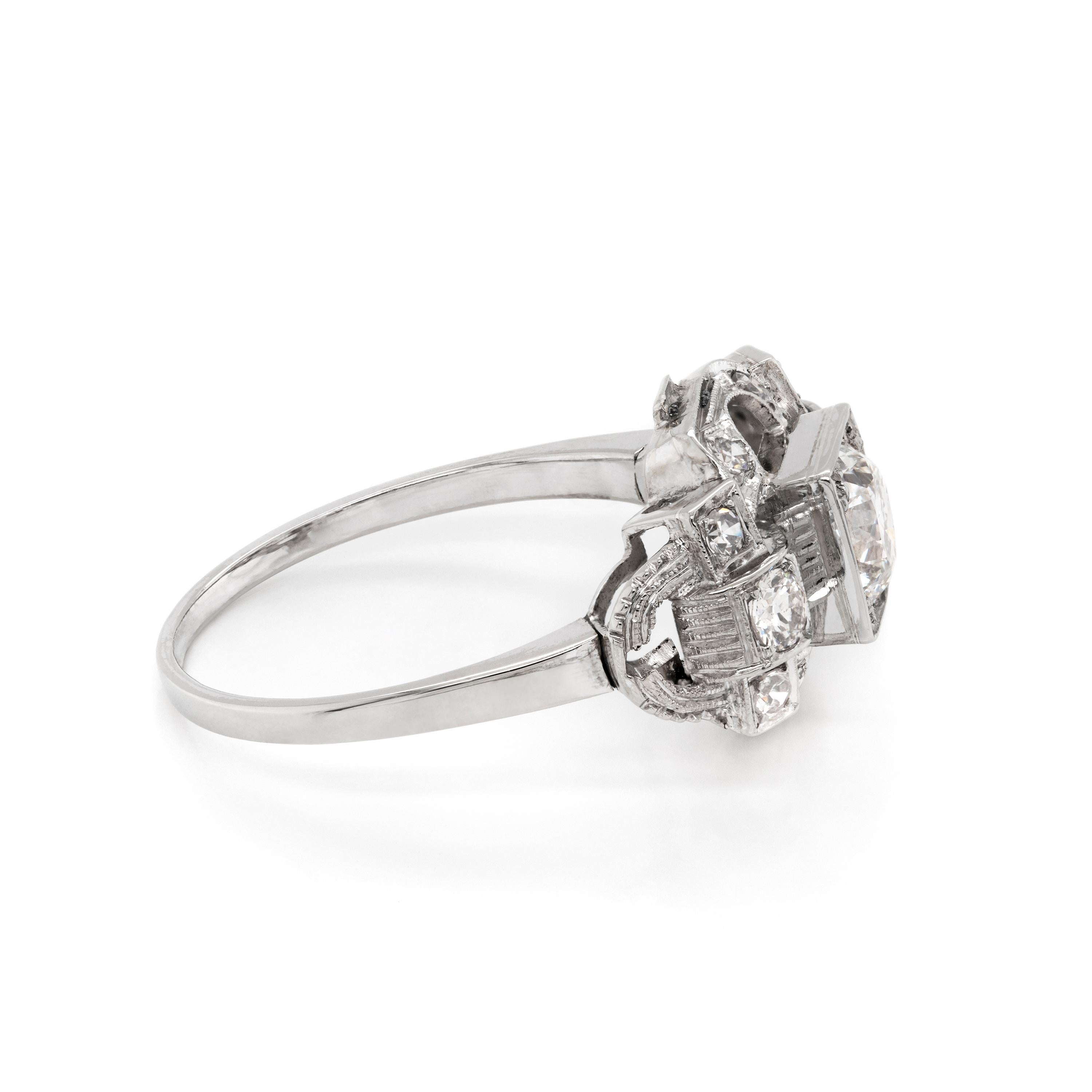 Beautiful handmade Art Deco engagement ring set with an old European cut diamond weighing 0.80 carats in the centre, complimented by 5 eight cut diamonds on either side within a very intricate open work mount. The rings design is undeniably Deco,