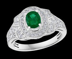 0.80 Carat Oval Cut Emerald and 0.85 Carat Diamond Ring 18 Karat White Gold