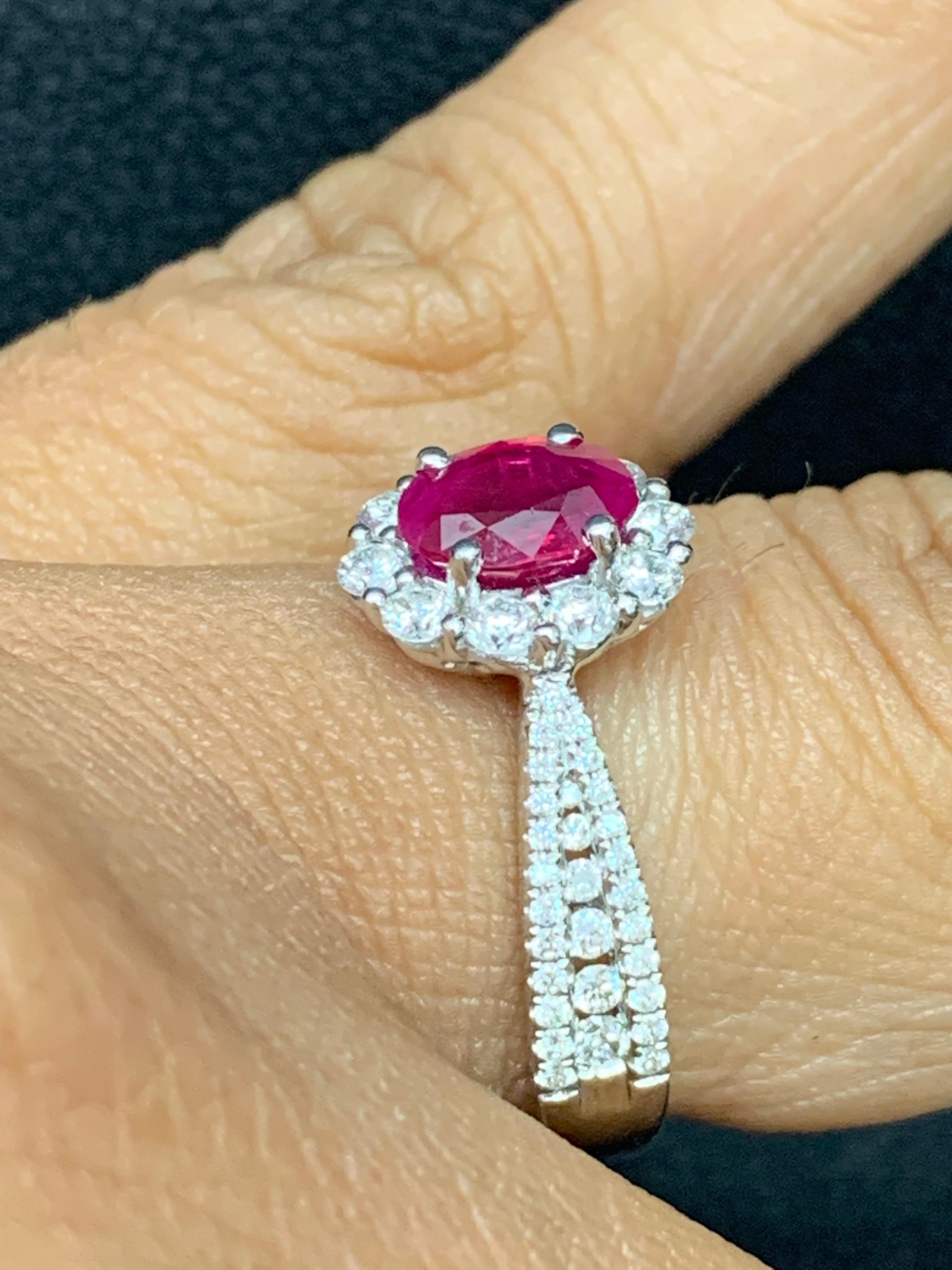 Features a 0.80 carat Oval cut ruby set in a 18k white gold setting that tapers as it gets to the center stone. The setting is micro-pave set with round brilliant melee diamonds on either side. 68 Accent diamonds weigh 0.64 carats in total. Size 6.5