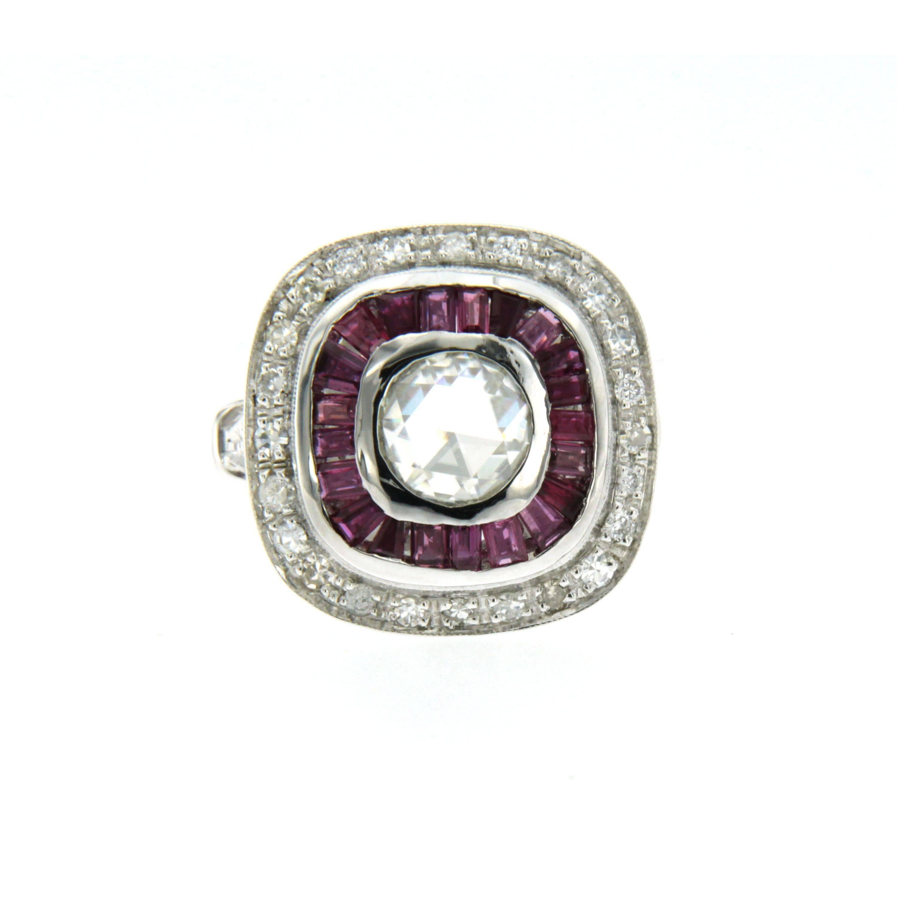Hand crafted in 18k gold Art Deco inspired ring features a sparkling and large .86 Old Mine cut diamond that is K color and SI2 clarity. The diamond is surrounded by a double halo of 1.50 carats well matched sparkling rubies and .70 carats of