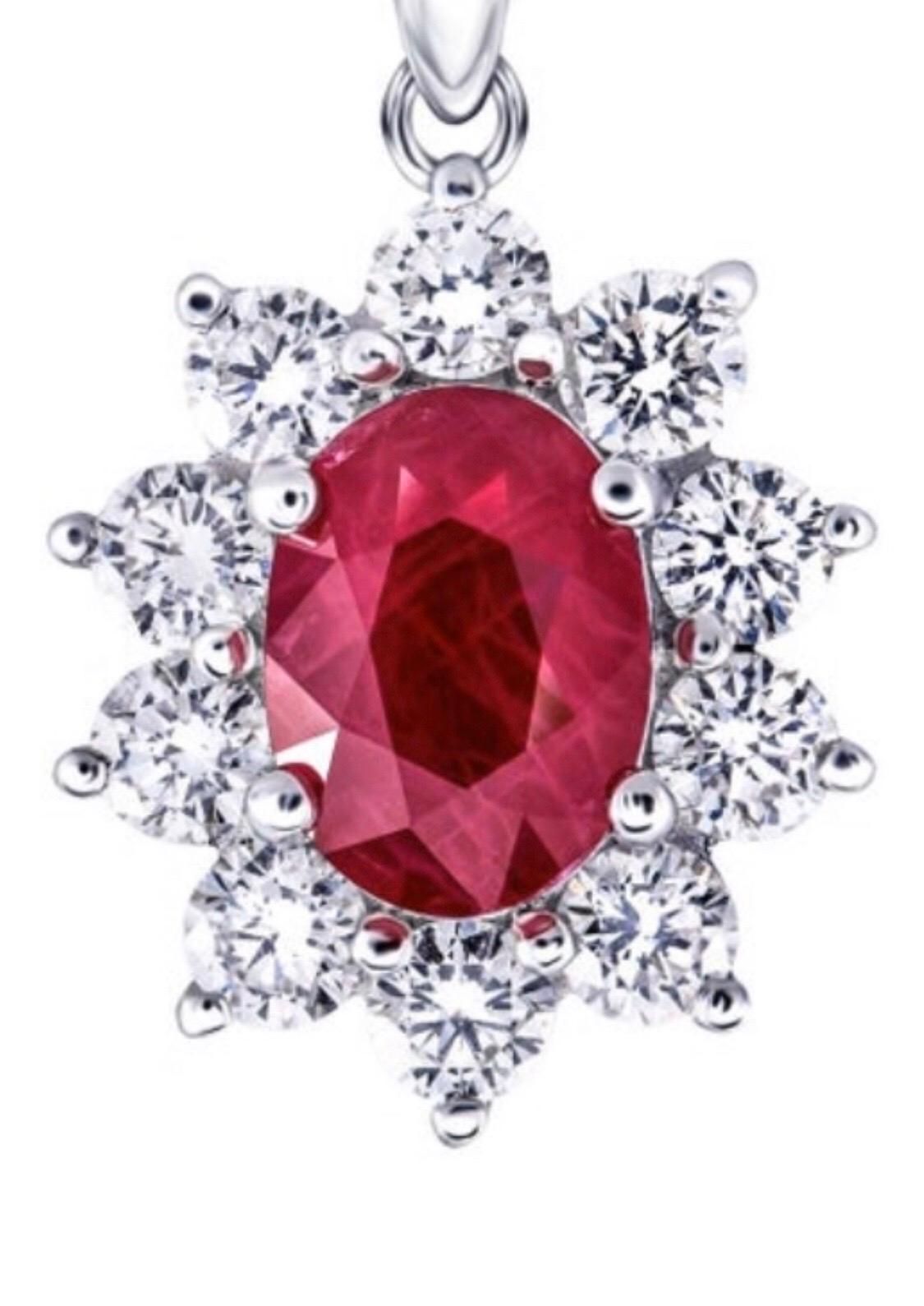 Ruby Cluster Pendant, The radiant oval ruby in the centre surrounded by 10 white stunning diamonds weighing a total of 0.30 carat color G/H clarity SI, the ruby weighs 0.50 carat beautifully crafted in a classic style claw set in 18 karat white