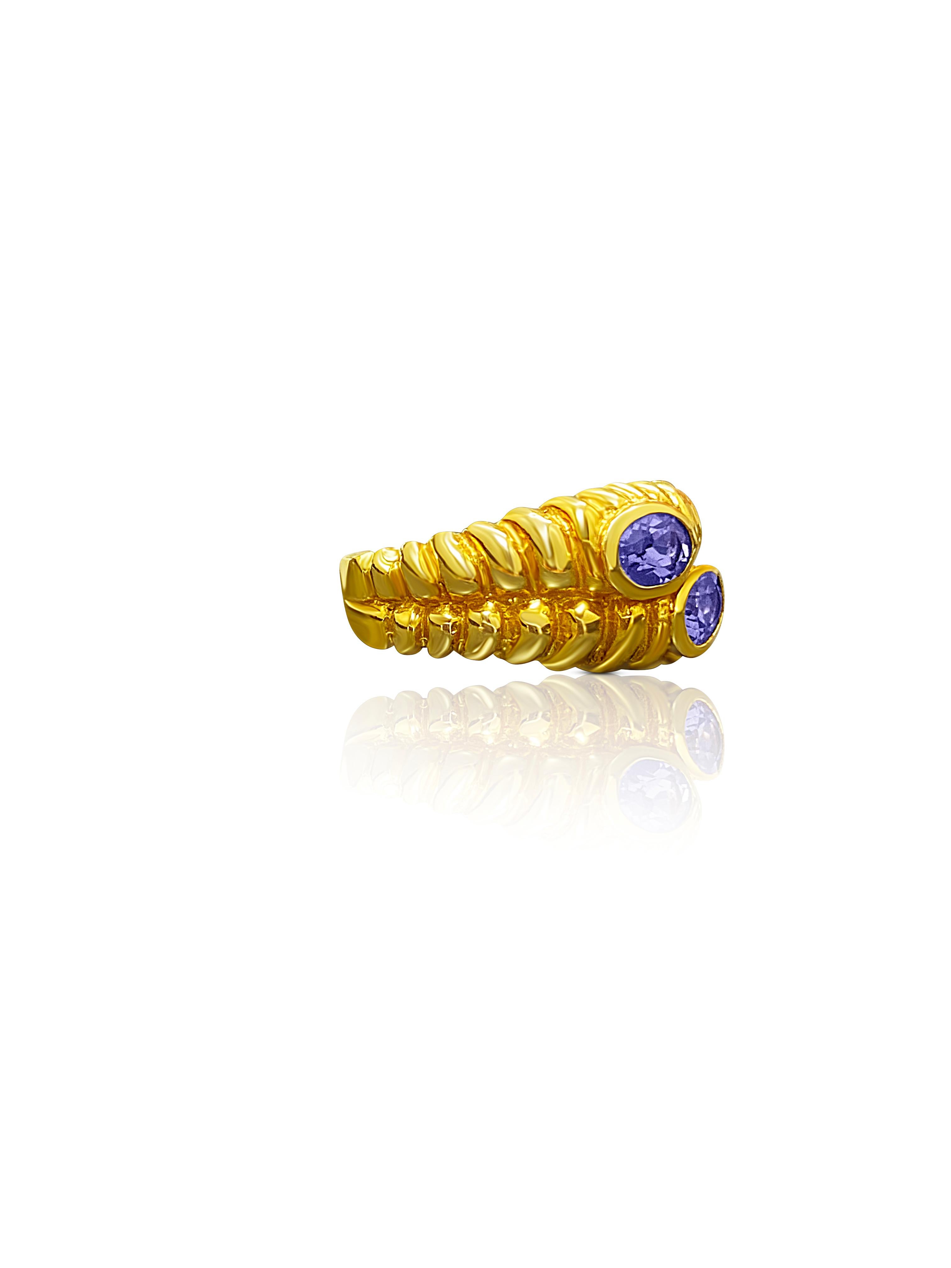 Centering twin Oval-Cut Tanzanites totaling 0.80 Carats and set in 14K Yellow Gold.

Details: 
✔ Stone: Tanzanite
✔ Tanzanite Weight: 0.80 carats (total weight)
✔ Tanzanite Cut: Oval
✔ Stone Origin: Tanzania
✔ Ring: 14K 