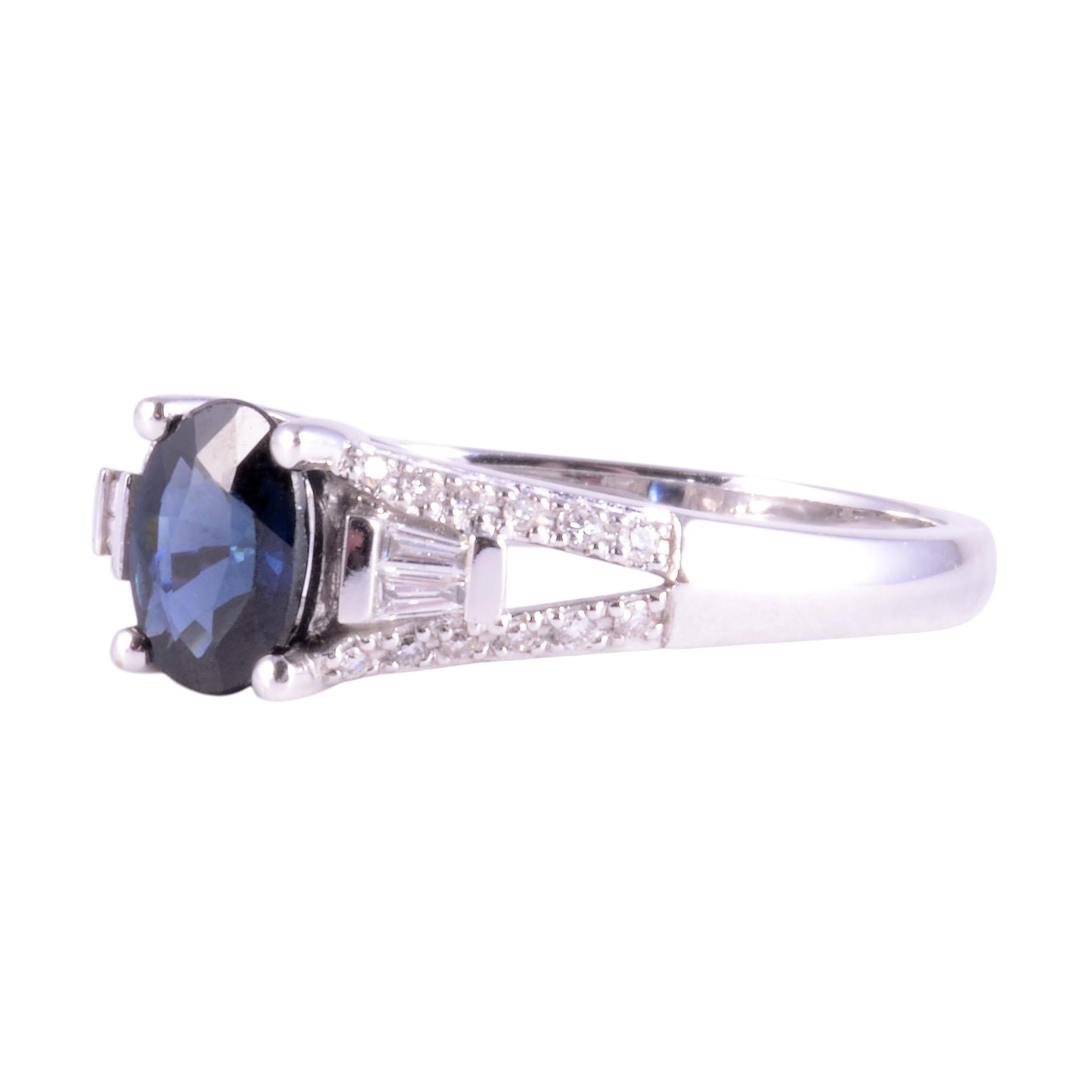 Estate 0.80 sapphire and VS diamond ring. This 14 karat white gold oval sapphire ring has .25 carat total weight diamonds with 24 round and baguette diamonds VS-SI clarity and G-H color. The sapphire measures approximately 7mm x 5mm and is a fine