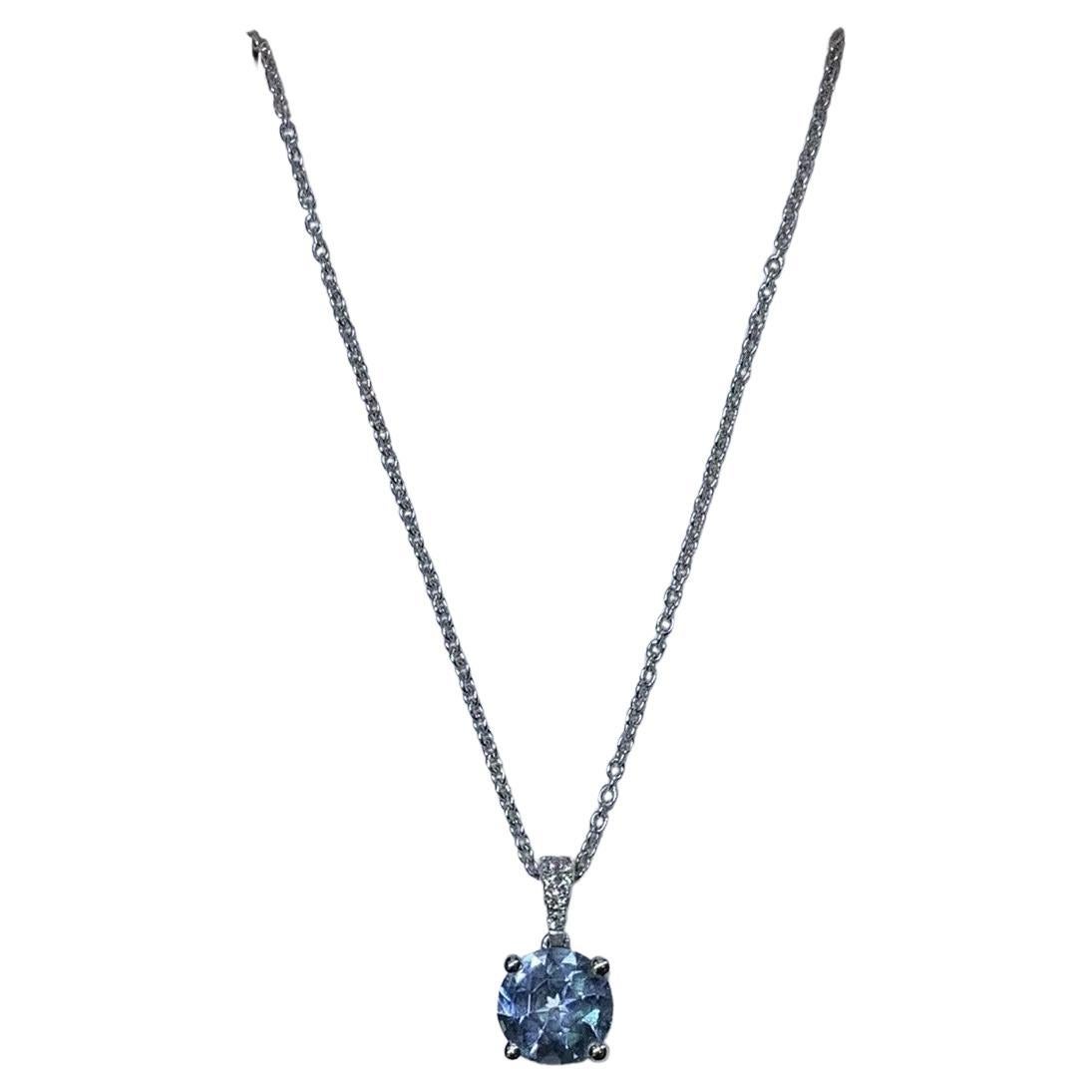 0.80ct Aquamarine and diamond halo pendant necklace in 18k white gold.