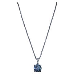0.80ct Aquamarine and diamond halo pendant necklace in 18k white gold.