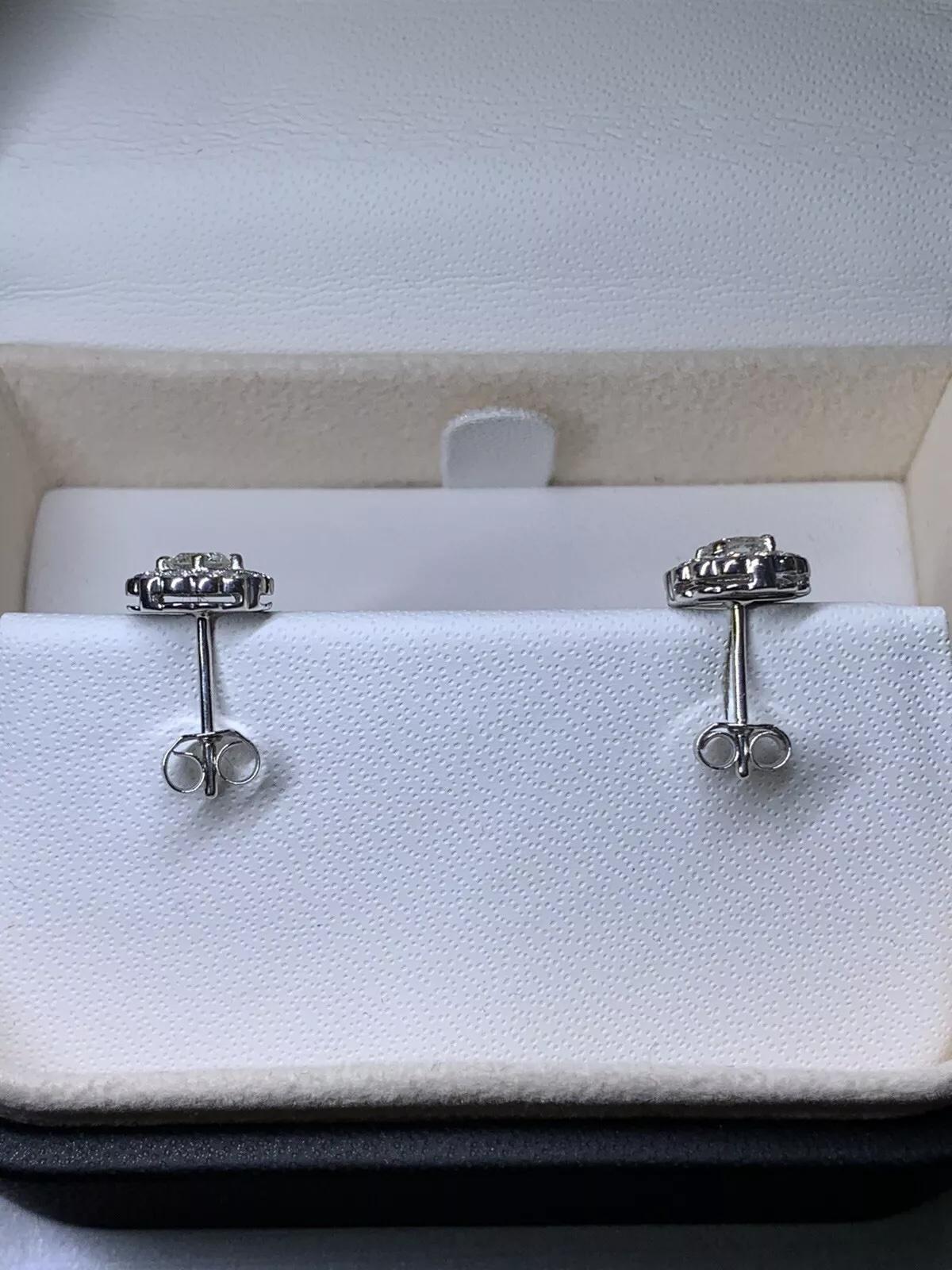 0.80ct Diamond halo solitaire stud earrings in 18k white gold.

Gorgeous matching diamond studs.

Hallmarked.

Diamond centre stone 0.50ct G colour VS1 clarity. Diamond Halo 0.30ct G colour VS1 clarity. 

Box and valuation included.
These stunning