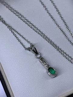 0.80ct Emerald green Colombian pendant with diamonds 18k white gold.