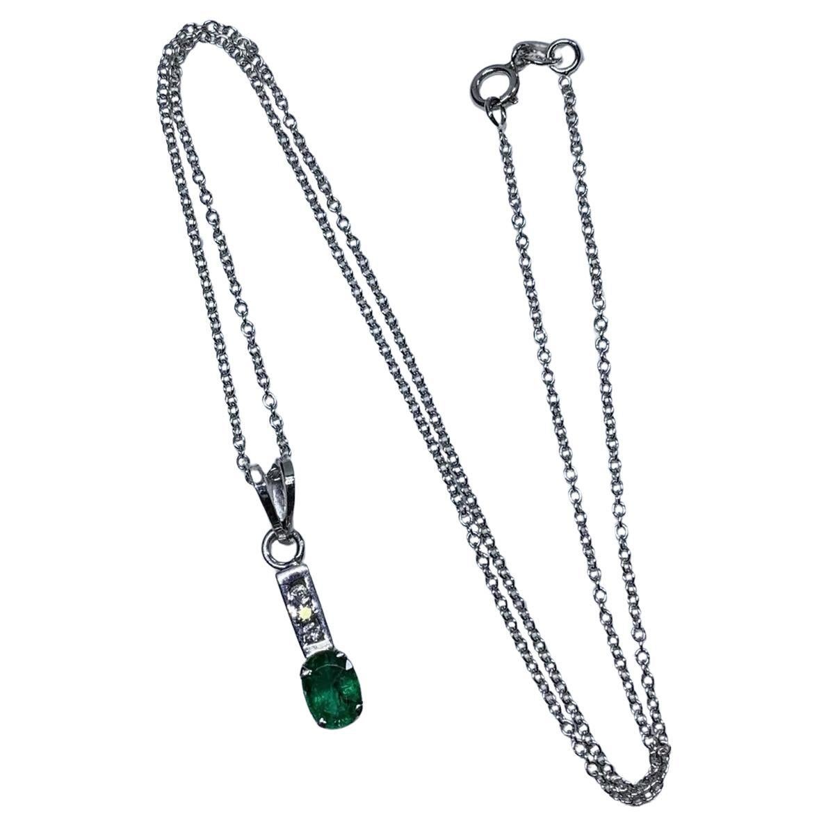 0.80ct Emerald green Colombian pendant with diamonds 18k white gold.