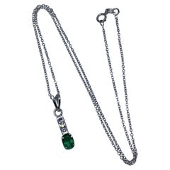 0.80ct Emerald green Colombian pendant with diamonds 18k white gold.
