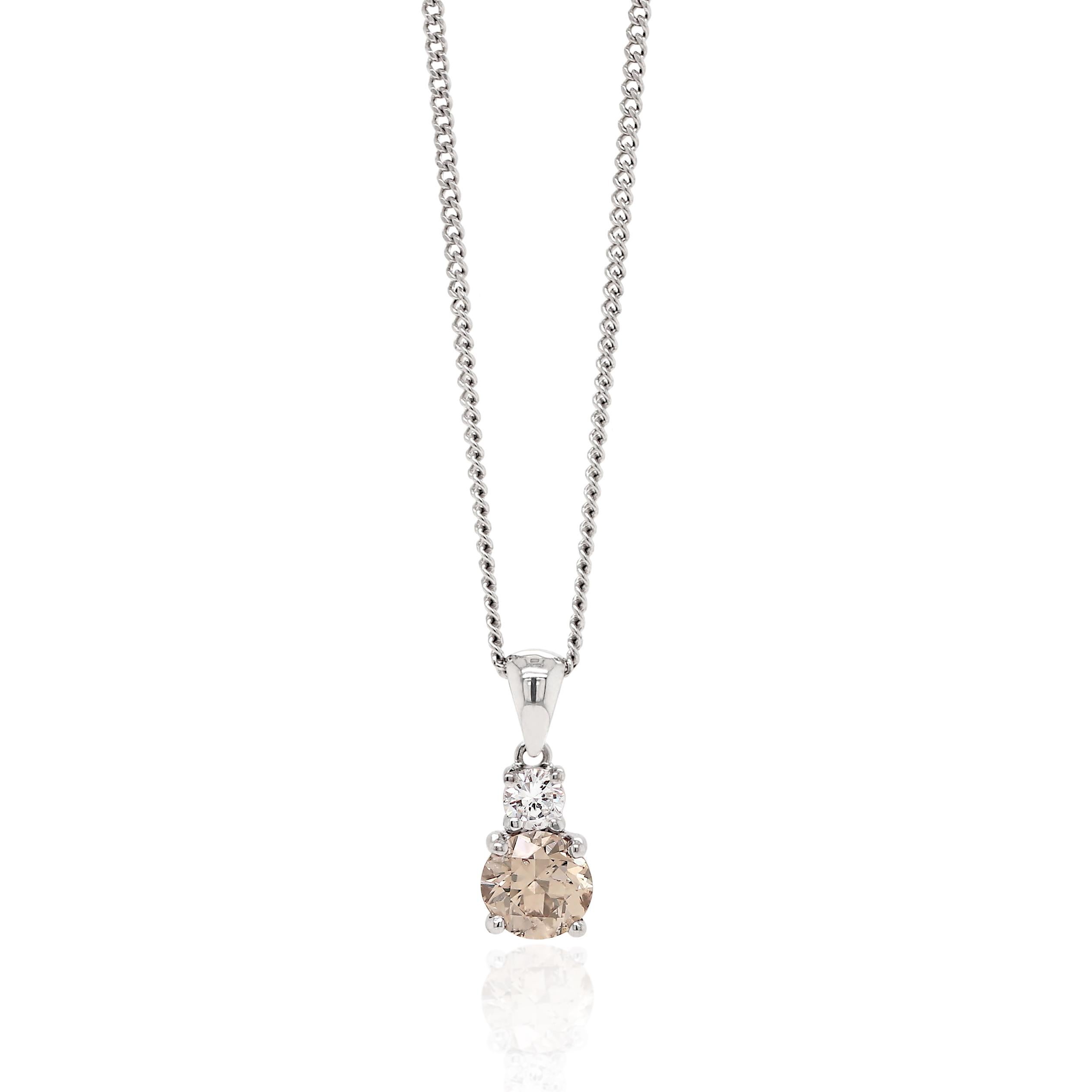Beautiful pendant featuring a fancy brown round brilliant cut diamond weighing 0.80ct in a four claw, open back setting. The diamond is wonderfully accompanied by a white round brilliant cut diamond above it weighing 0.12ct in a four claw setting,