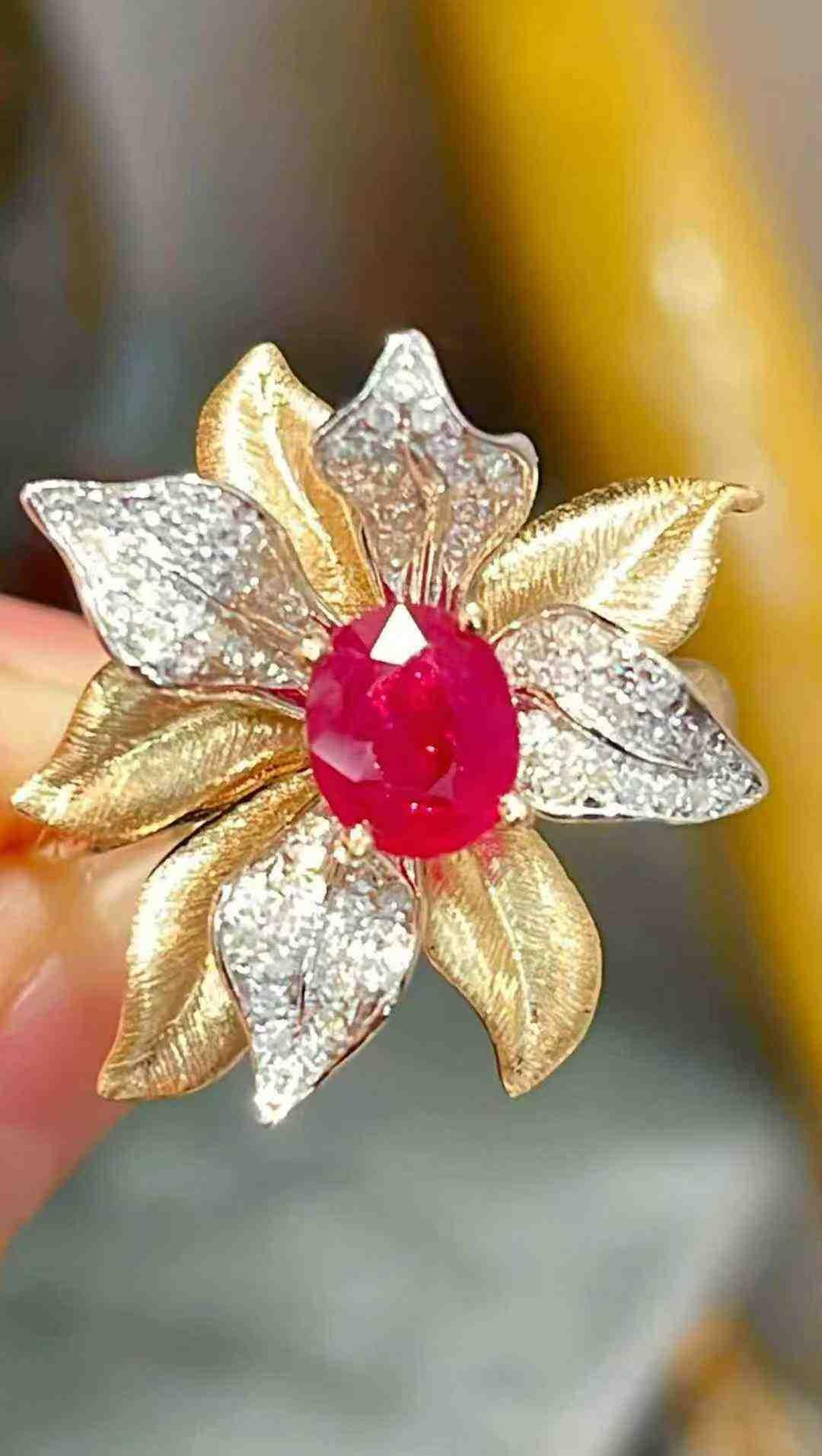 This exquisite flower cocktail ring features a vibrant 0.80ct ruby at its center, surrounded by 0.30ct of sparkling diamonds, all set in luxurious 18K yellow gold. The rich warmth of the gold perfectly complements the deep red hue of the ruby, while