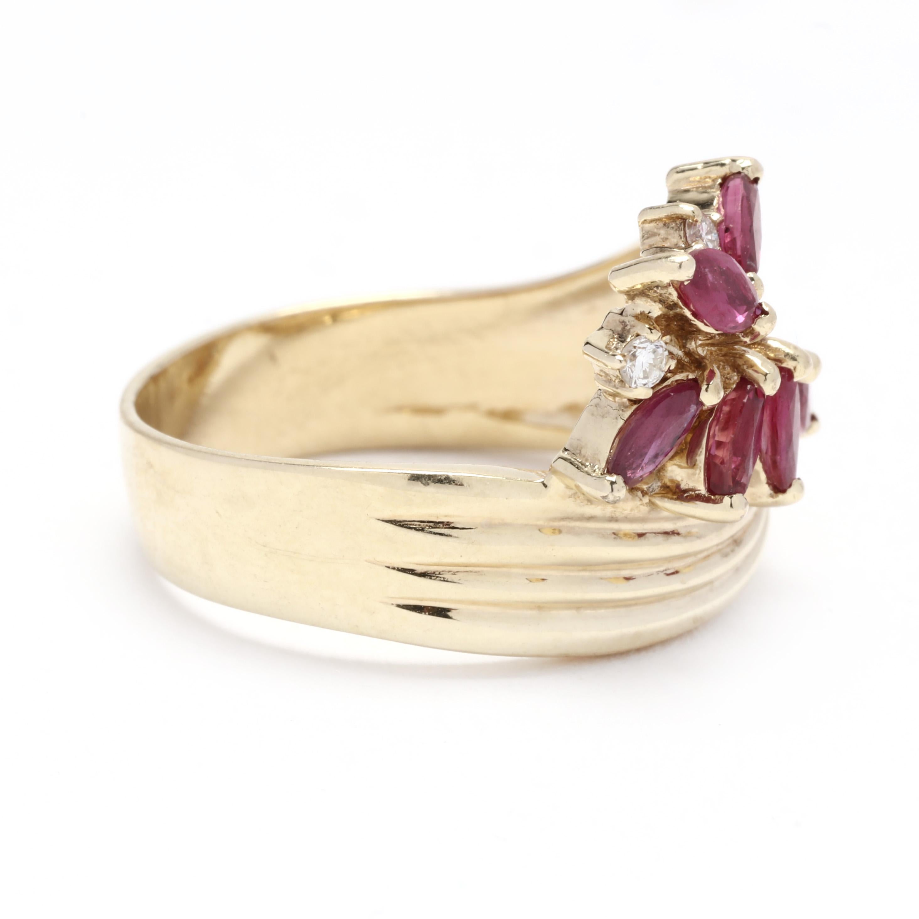 A vintage 14 karat yellow gold ruby and diamond cluster bypass ring. This July birthstone ring features a cluster of marquise cut rubies weighing approximately .75 total carats with round brilliant cut diamonds weighing approximately .05 total
