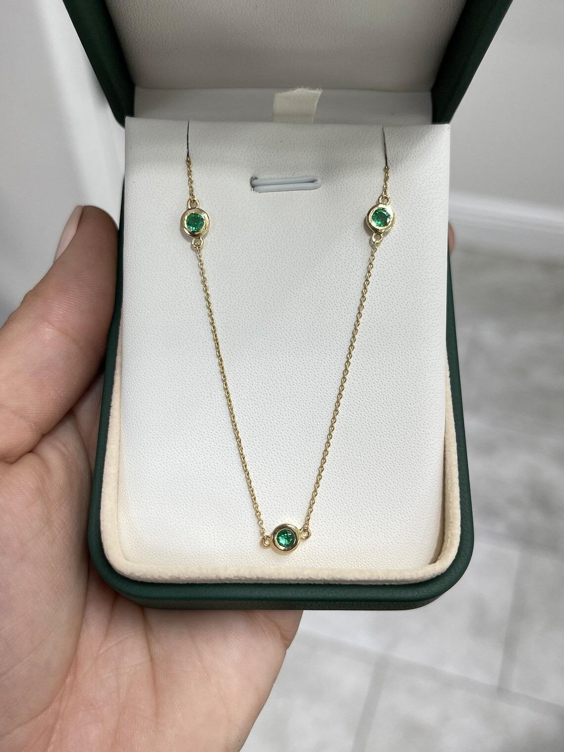 A remarkable emerald by the yard necklace crafted to perfection. This piece features five, stunning natural round-cut emeralds from the origin of Zambia; which showcase a desirable medium-dark green color, with very good clarity and luster.