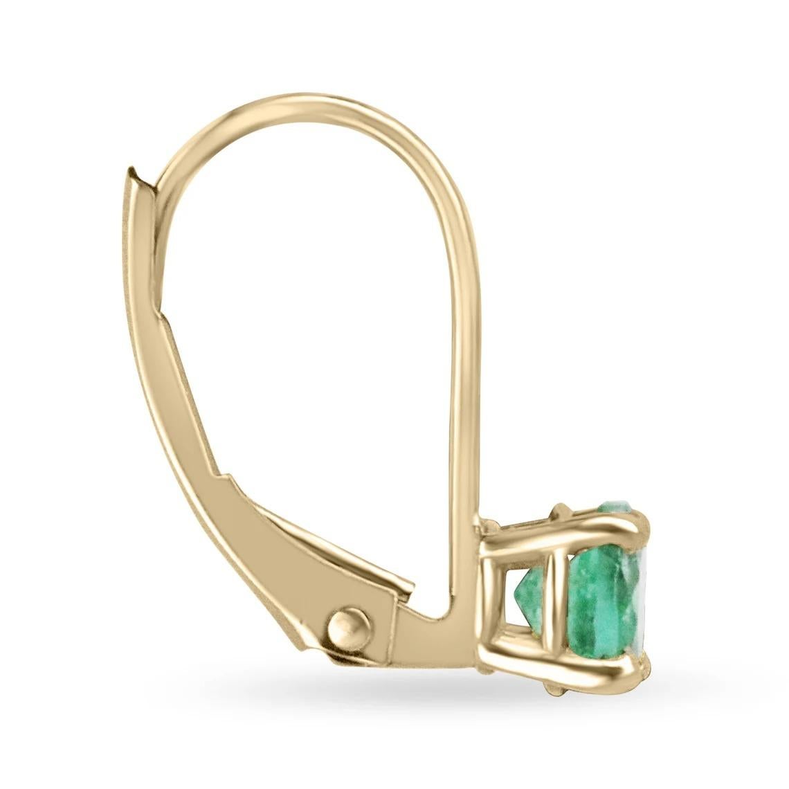 An everyday pair of round-cut-emerald lever back earrings made in 14K yellow gold. The chic pair of lever-back earrings feature green, natural emeralds. The emeralds have beautiful eye clarity and are simply vivacious! The emeralds display minor