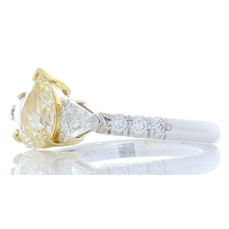 Tell her you’ll cherish her for a lifetime when you present your love with this stylishly sophisticated diamond ring. A fiery fancy lemon yellow pear shape diamond sits at the heart of this ring. The 0.81 carat 8.19 X 5.26 millimeter diamond is