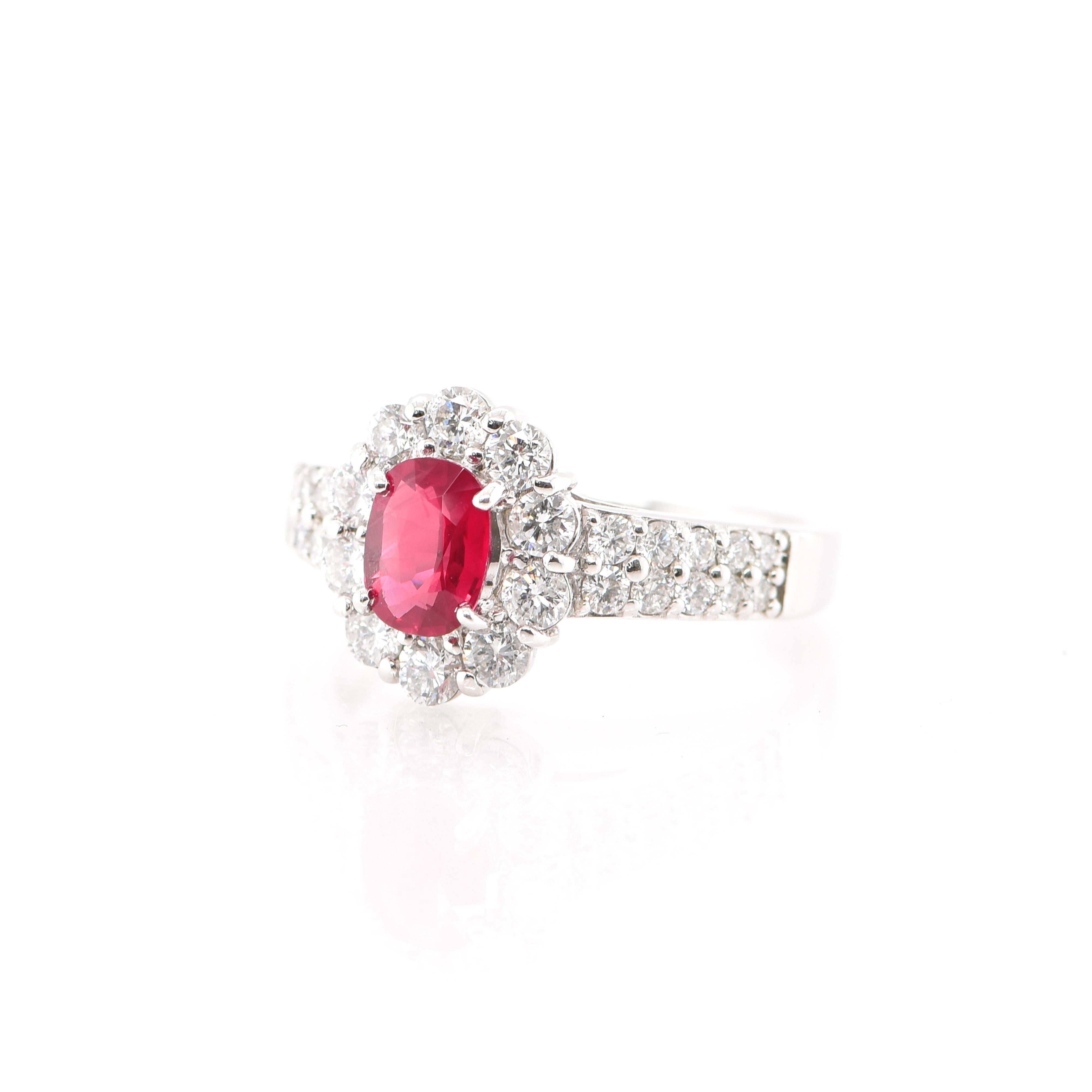 A beautiful Halo Ring featuring a 0.81 Ruby and 1.00 Carat of Diamond Accents set in Platinum. Rubies are referred to as 