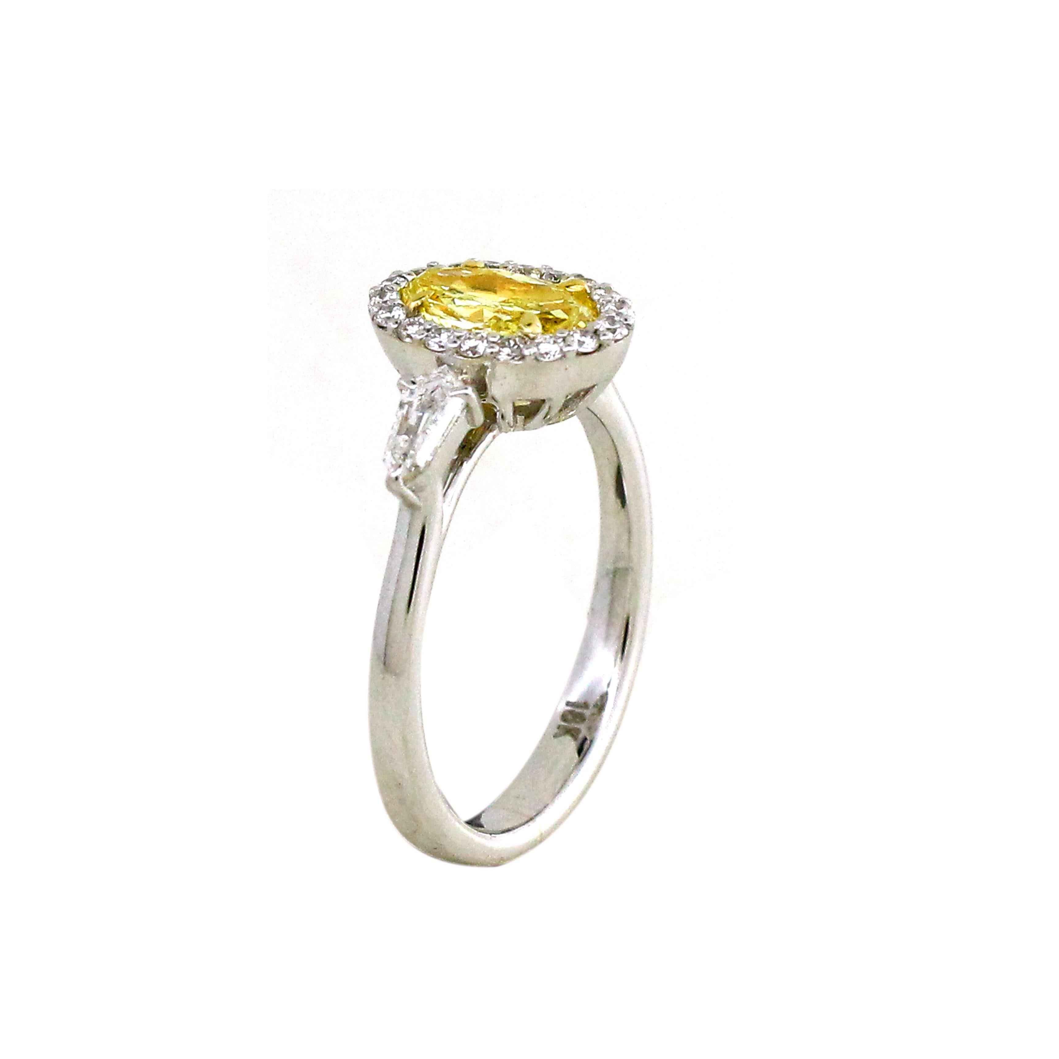 Introducing a masterpiece that radiates with a harmonious fusion of elegance and individuality. At the heart of this enchanting ring, a mesmerizing 0.81-carat center yellow diamond takes center stage. 
Surrounding this radiant centerpiece is a