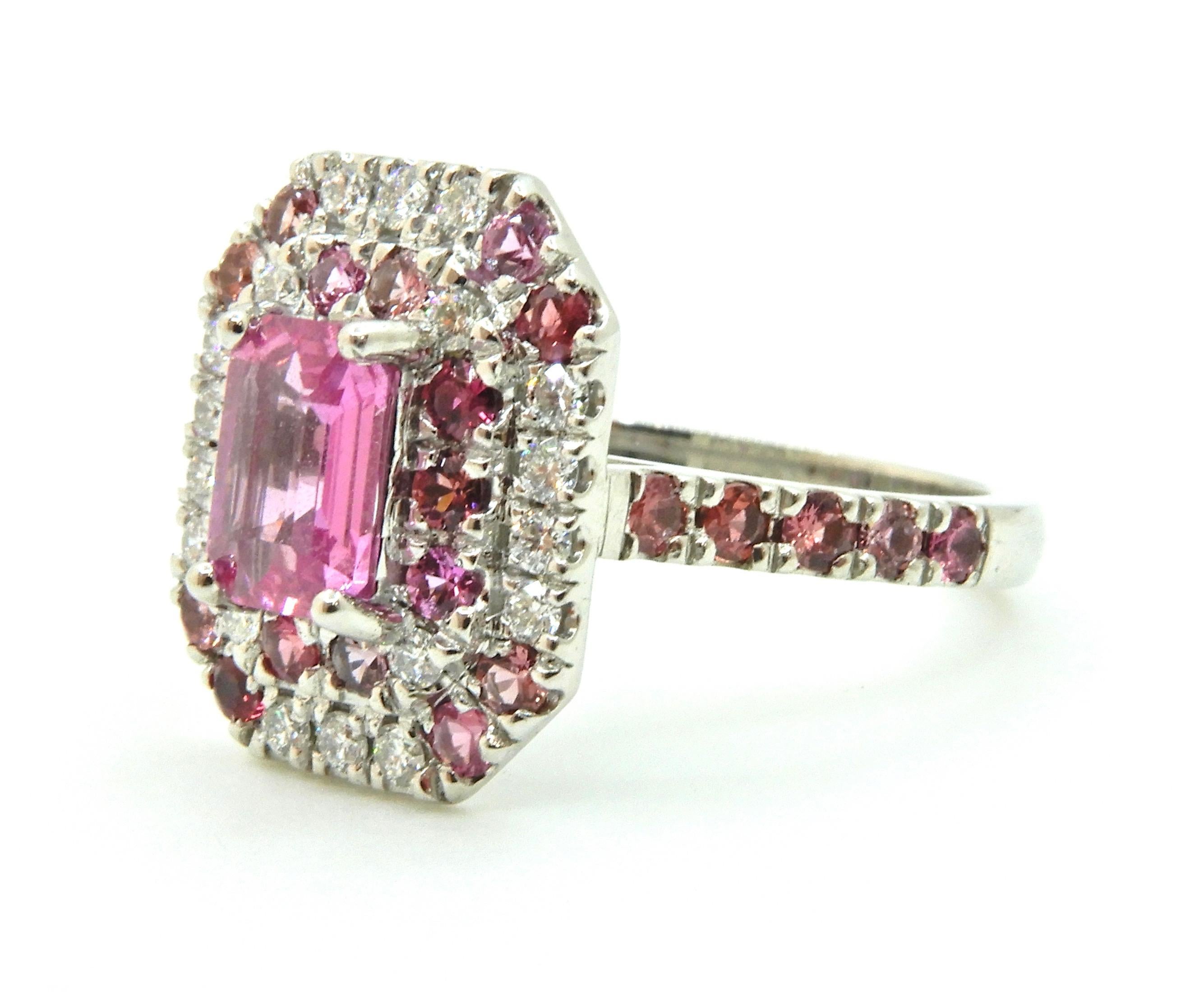 An explosion of pink and sparkles, this 0.82 Carat Pink Sapphire Diamond Double Halo 18 Carat White Gold Engagement Ring is a gorgeous one-off piece.

The rounded, flat edge band splits into an under-rail and upswept shoulders, each set with five