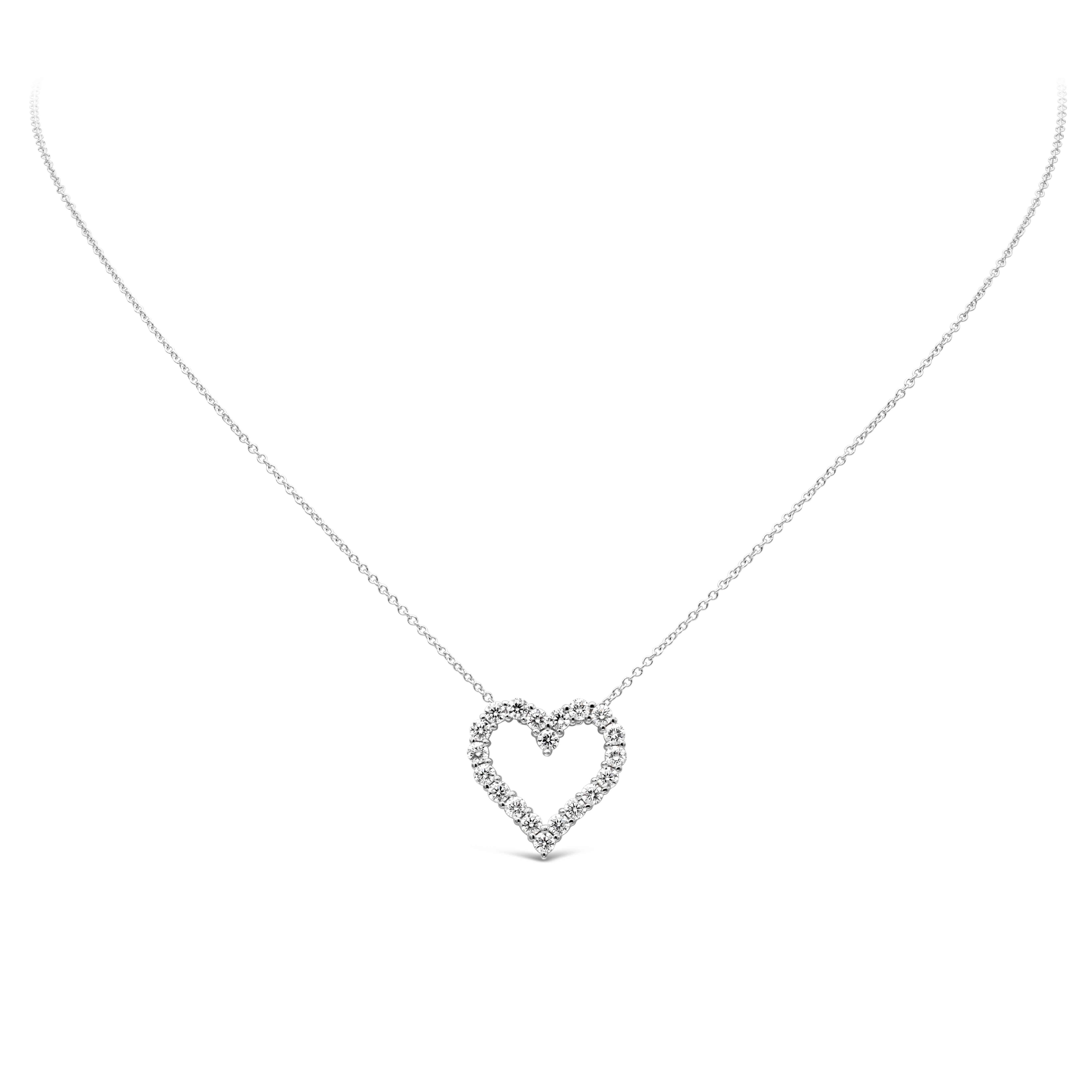 A simple and unique pendant necklace showcasing a row of round brilliant diamonds weighing 0.82 carats total, F color VS-SI1 clarity. Set in an open-work heart shape mounting made in 18K White Gold and shared prong setting. Suspended on an 18 inch